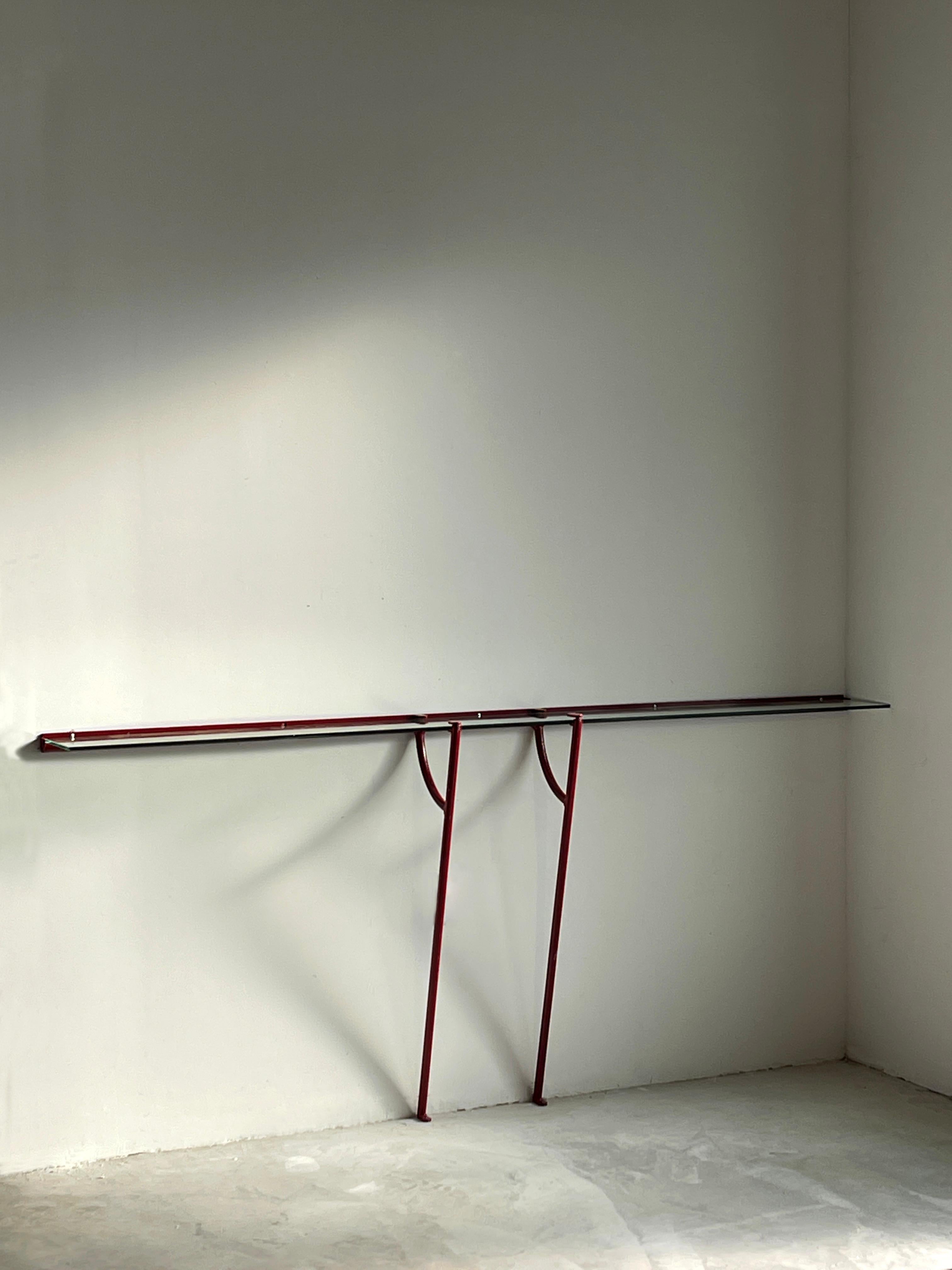 A sizable wall-mounted console, produced in Italy, 1960s. Original cut glass is framed in red-lacquered metal. With lively original patina. 

Other designers of the period include Gio Ponti, Fontana Arte, Max Ingrand, Franco Albini, and Jean