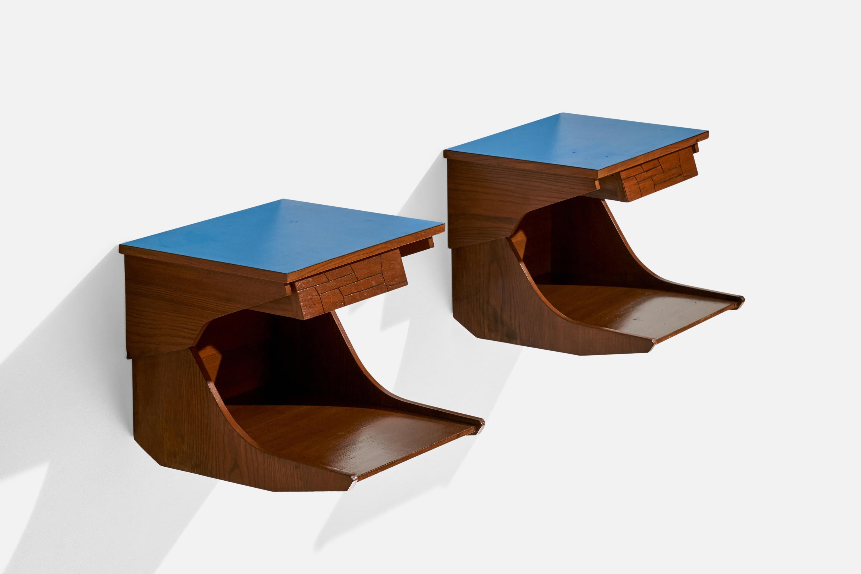 A pair of walnut and blue-laminate wall mounted nightstands designed and produced in Italy, dated 1956.