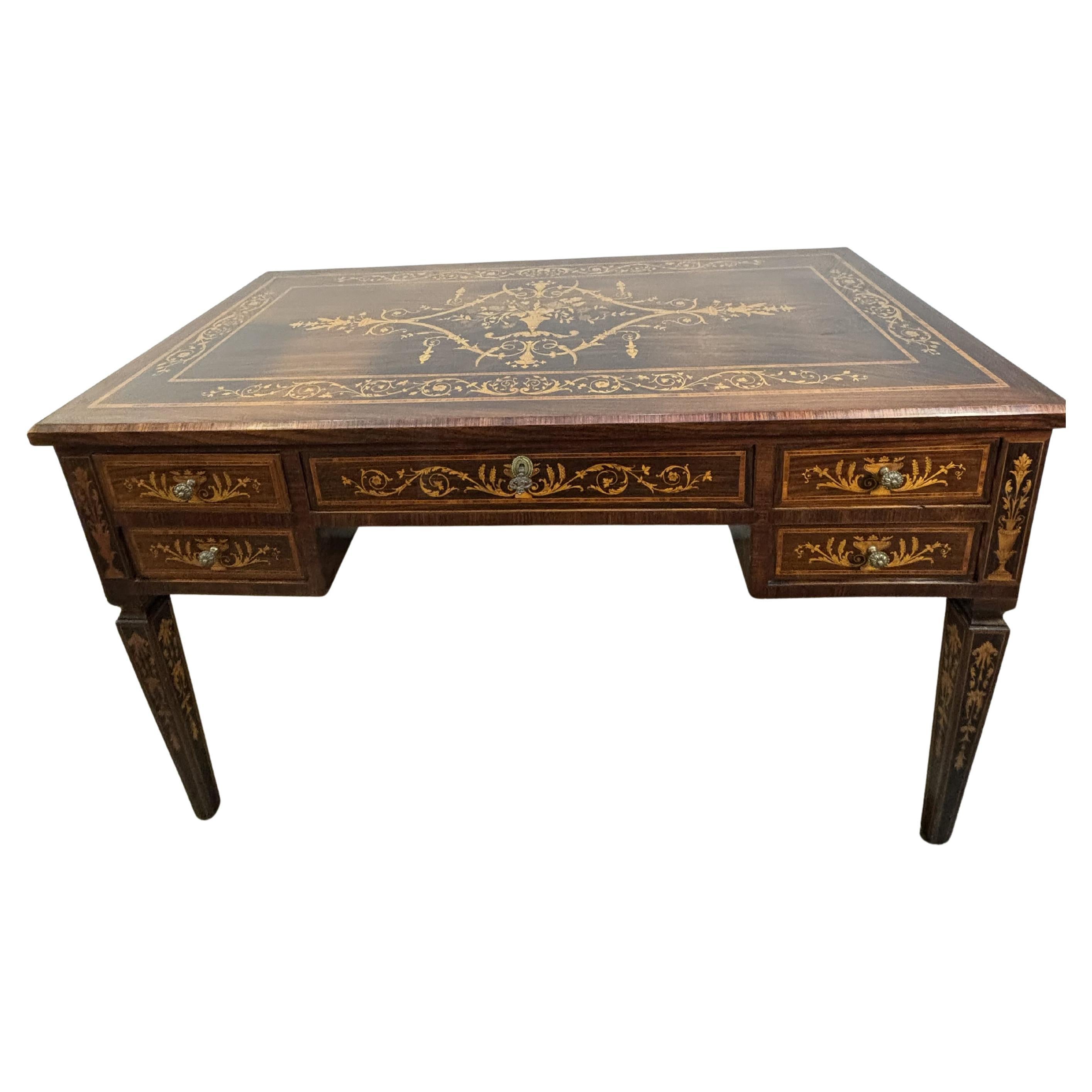 Desk in precious wood and finely executed marquetry, inspired by the work of Giuseppe Maggiolini (1738-1814), a cabinetmaker renowned for his detailed neoclassical marquetry. 
Desk in rosewood, mahogany and walnut veneer, with marquetry in boxwood