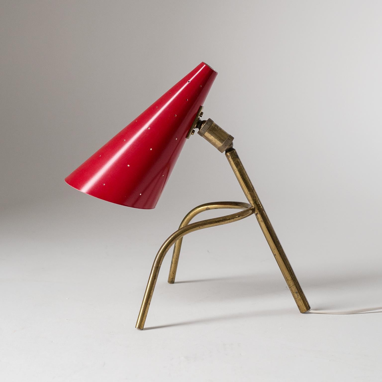 Rare Italian desk lamp, circa 1950. Very unique tripod design with a lacquered and pierced aluminum cone shade. The pierced shade, which resembles early O-Luce wall lights, can be rotated and tilted 360º by way of the rare double-joint it is