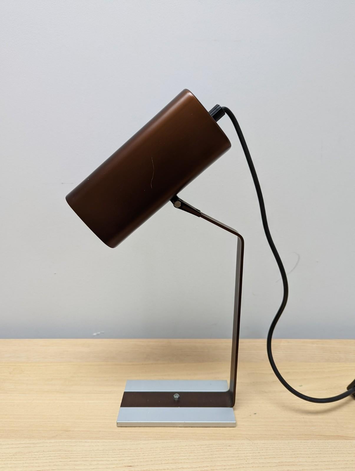 A stunning Italian mid-century desk lamp.

The lamps manufacturer is unknown but labelled underneath as 'made in Italy'
 
The colour of the lamp is superb brown with a contrasting silver base

Condition - the lamp is in in very good apart from