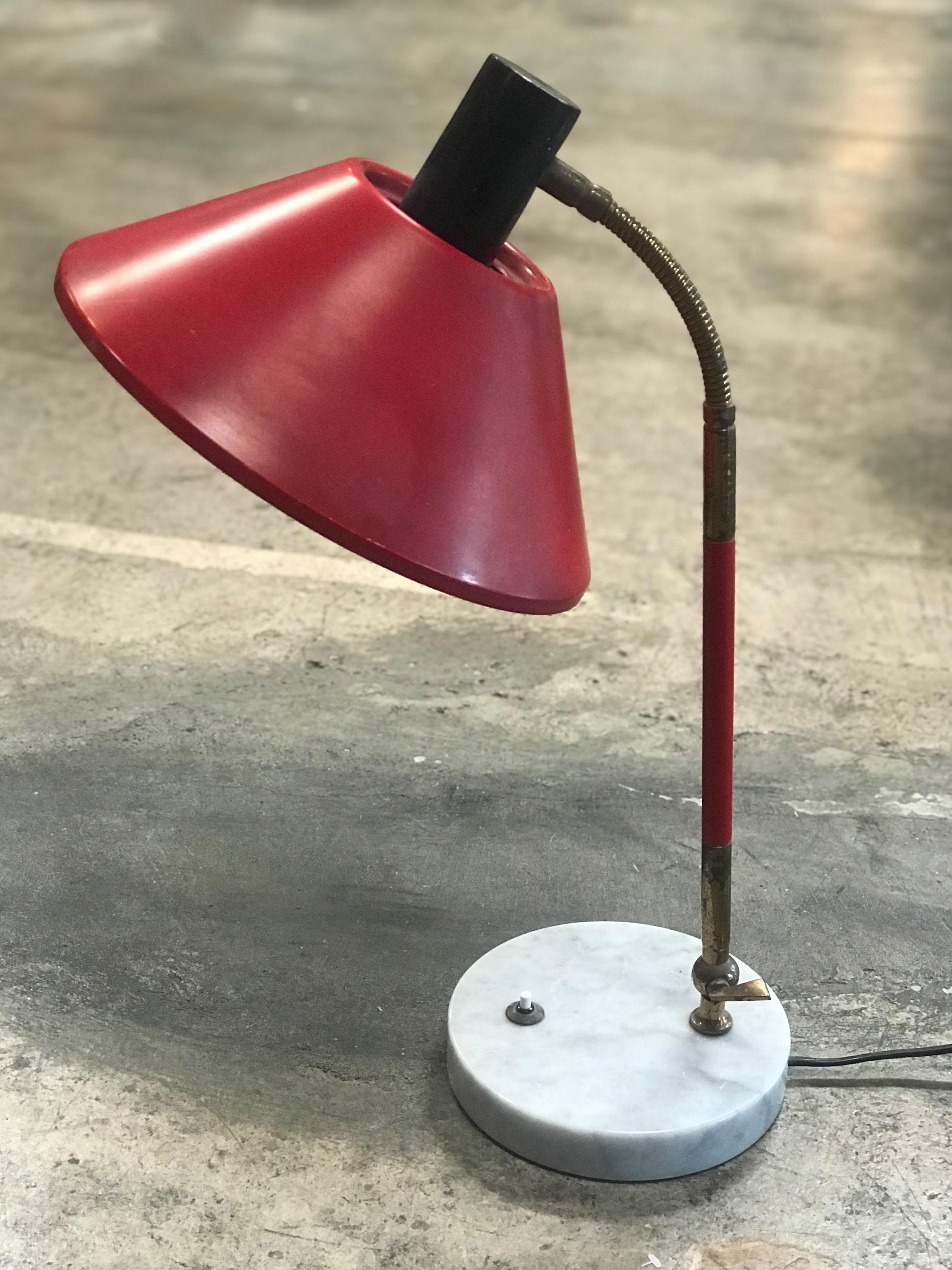 Stilux desk lamp, marble, metal red lacquered, brass, Italy, 1950s.

Stylish desk light with mirrored shade. The circular shade matched the brass stem and the marble base perfectly. The base is a white marble circle (Diam. 7