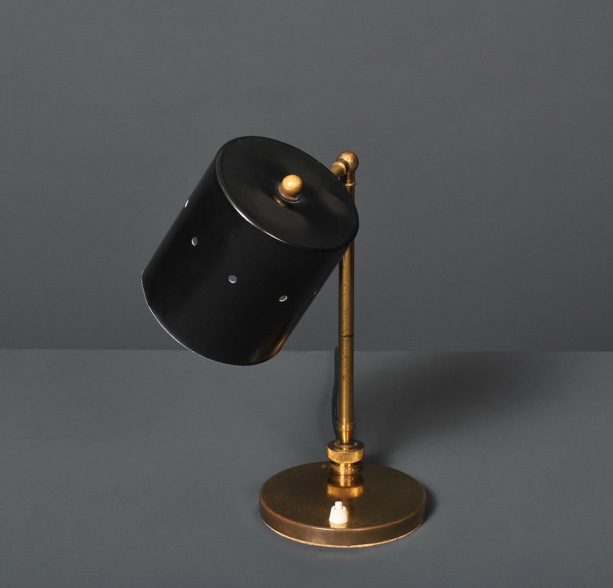 A characterful midcentury Italian desk or table lamp. Brass with black painted steel shade. Multidirectional adjustable ball and socket joint. Rewired.
