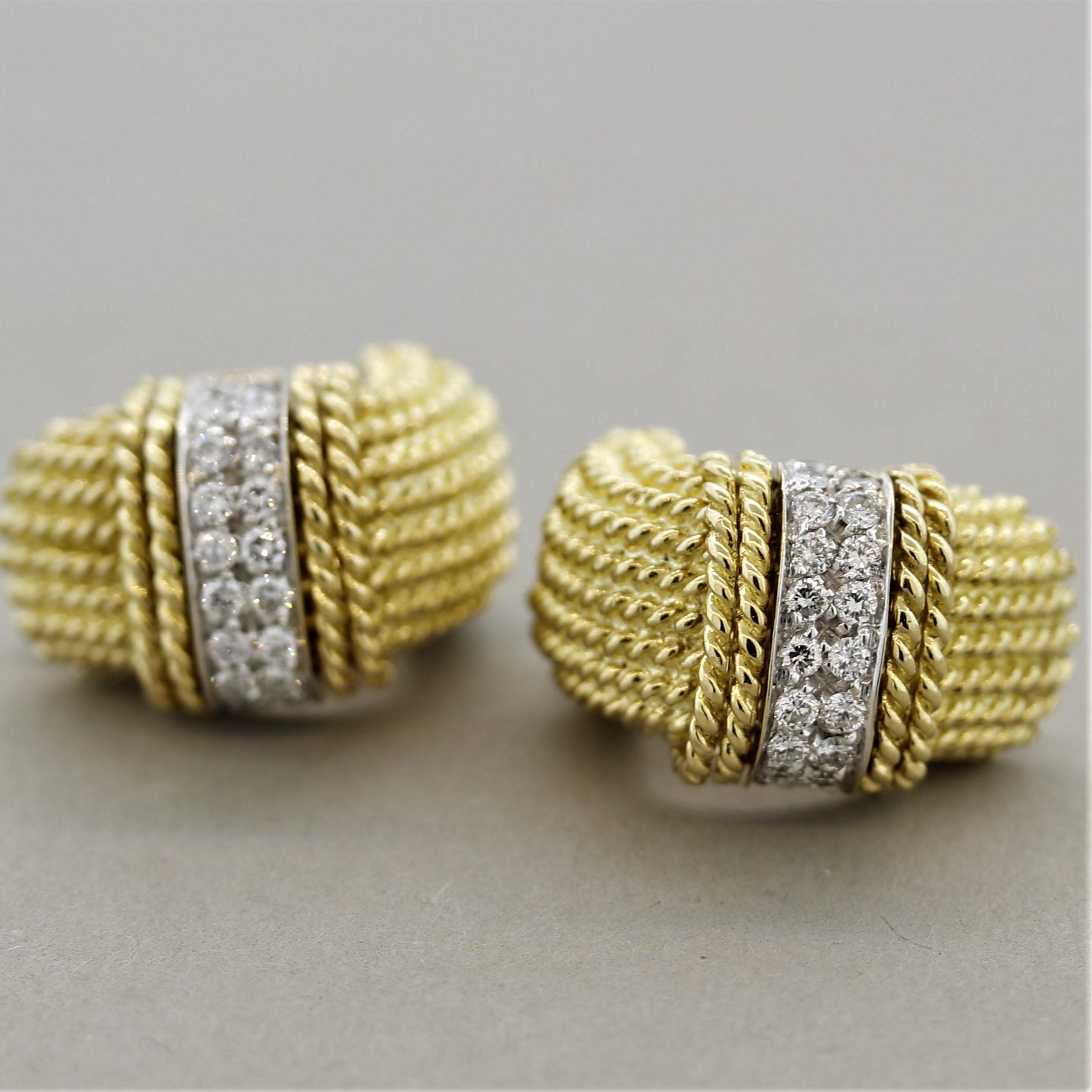 A stylish pair of diamond earrings made in Italy. They feature 0.40 carats of round brilliant cut diamonds set in rows of two. On the back of each earring is a single round cut ruby adding a special touch to the piece. Made in 18k yellow gold with