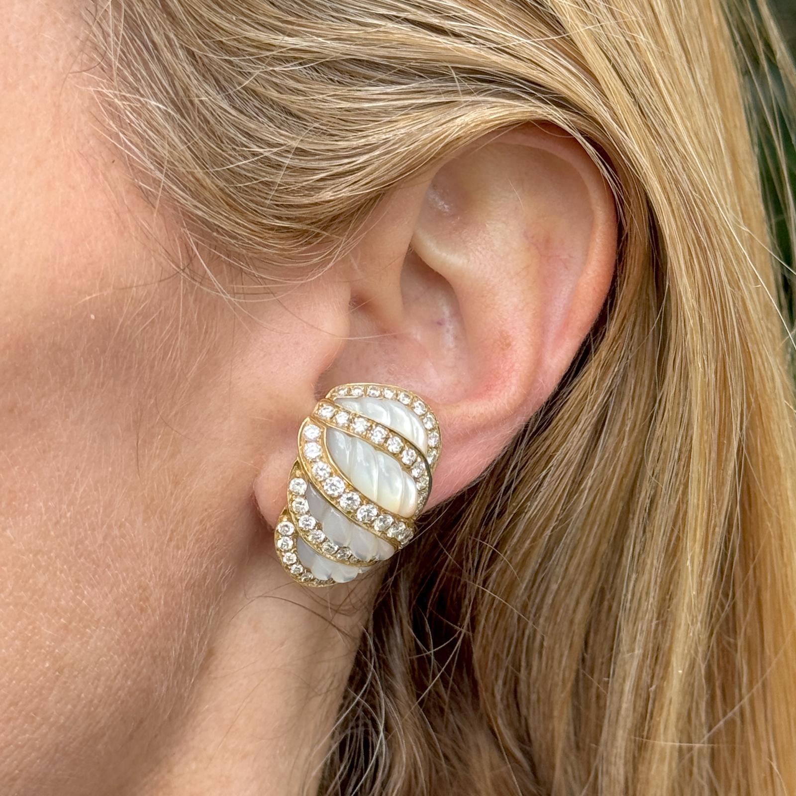 Elegant Italian diamond and carved mother of pearl earrings handcrafted in 18 karat yellow gold. The shrimp style earrings feature 98 round brilliant cut diamonds weighing approximately 5.00 carat total weight and graded F-G color and VS clarity.