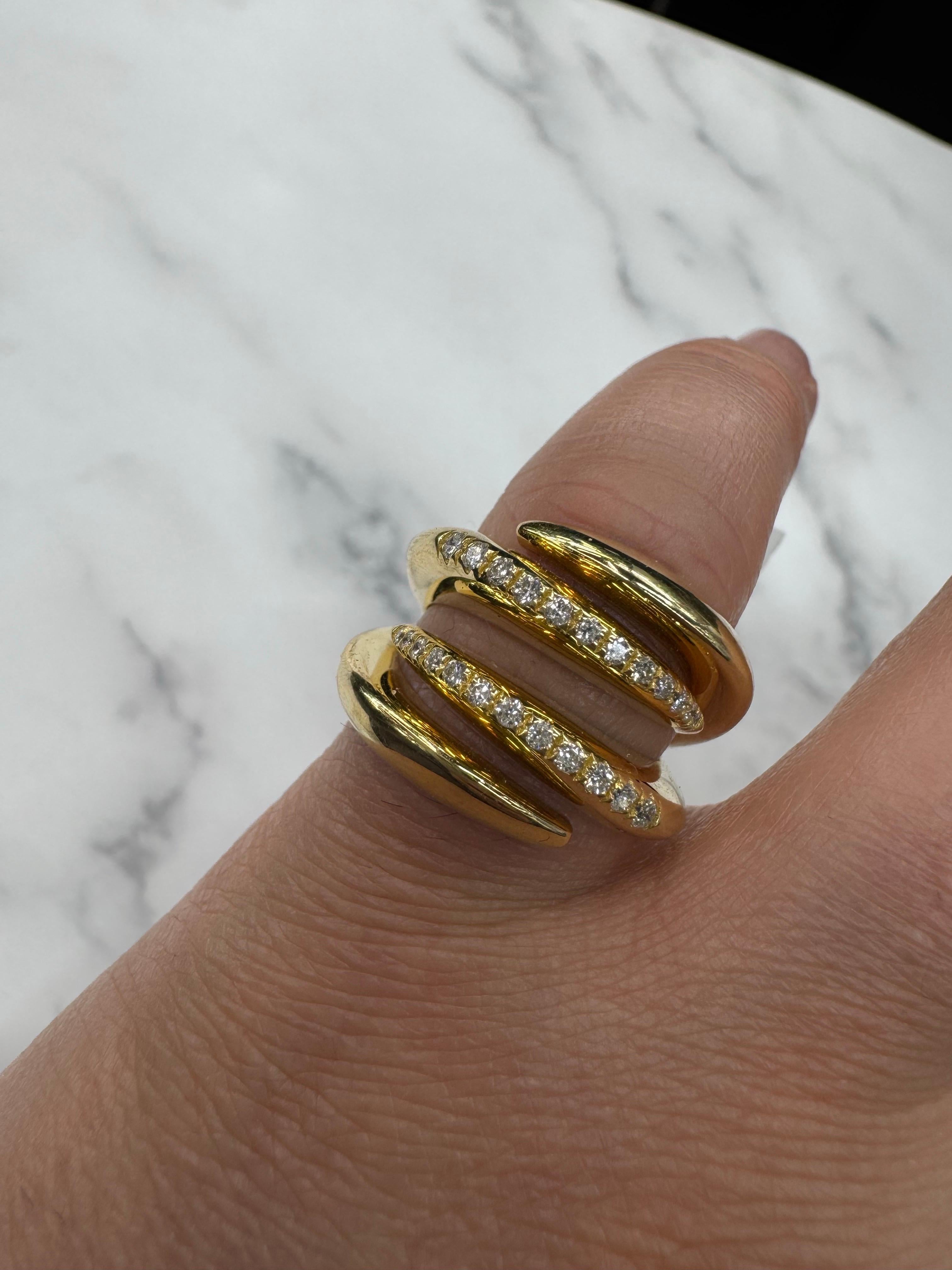 Crafted in Italy, this bold and sculptural ring showcases modern elegance in luxurious 18 karat yellow gold. The dynamic, multi-band design is accented with 24 round brilliant-cut diamonds, totaling 0.28 carats, with exceptional F color and VS1–VS2