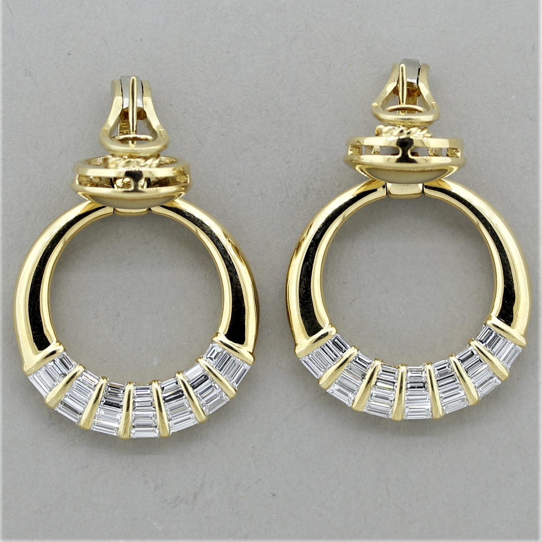 A special pair of door knocker earrings made in Italy! They feature 5 carats of exceptionally fine baguette-cut diamonds which are channel set in graduating sizes. They are VVS in clarity and F in color, top quality stones. The hoops move and sway