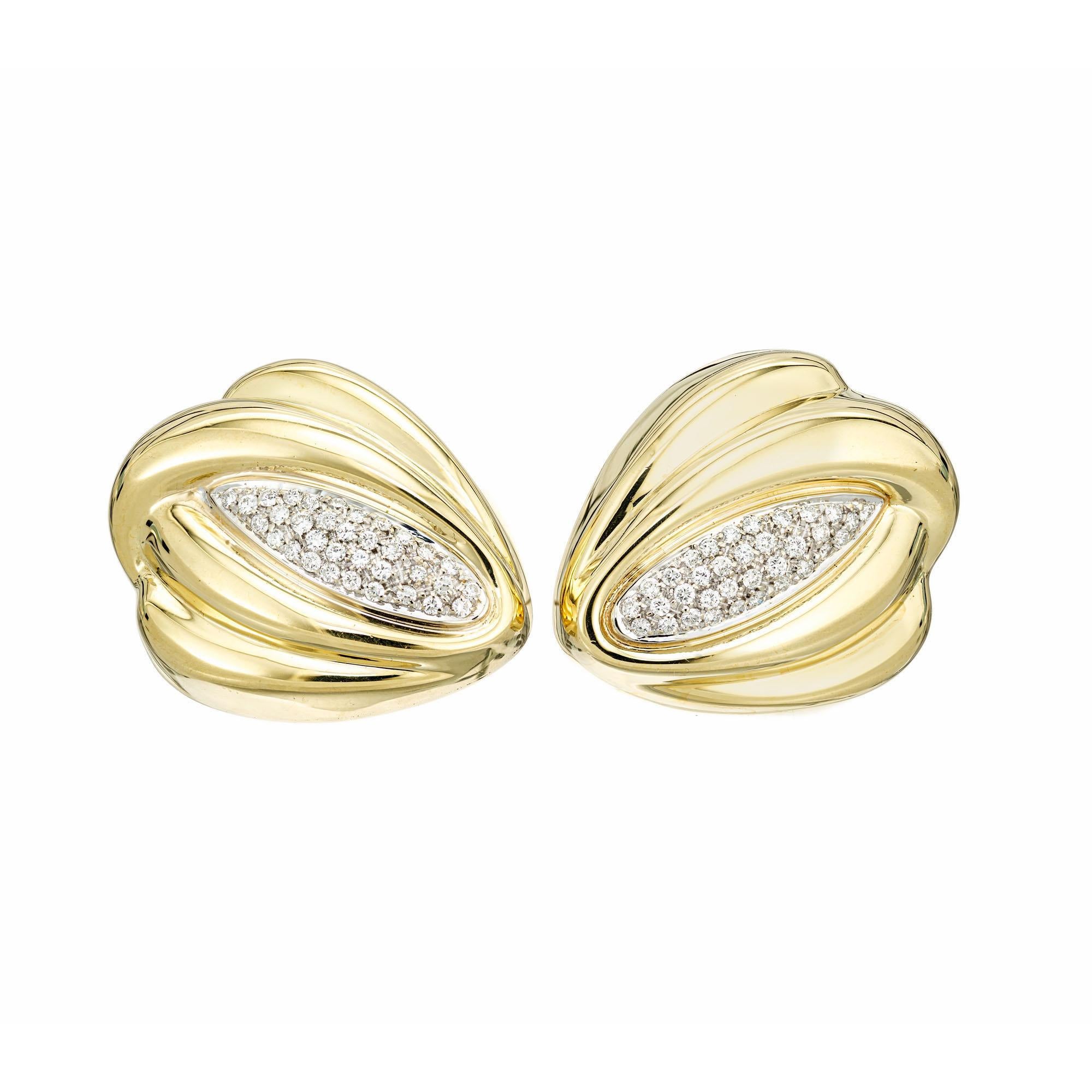 Mid-Century Italian 18k yellow gold swirl design earrings with white gold clips and posts and white gold under pave diamonds. Circa 1960.

70 round full cut diamonds, approx. total weight .65cts, F-G, VS
18k Yellow Gold
Tested: 18k
Stamped: