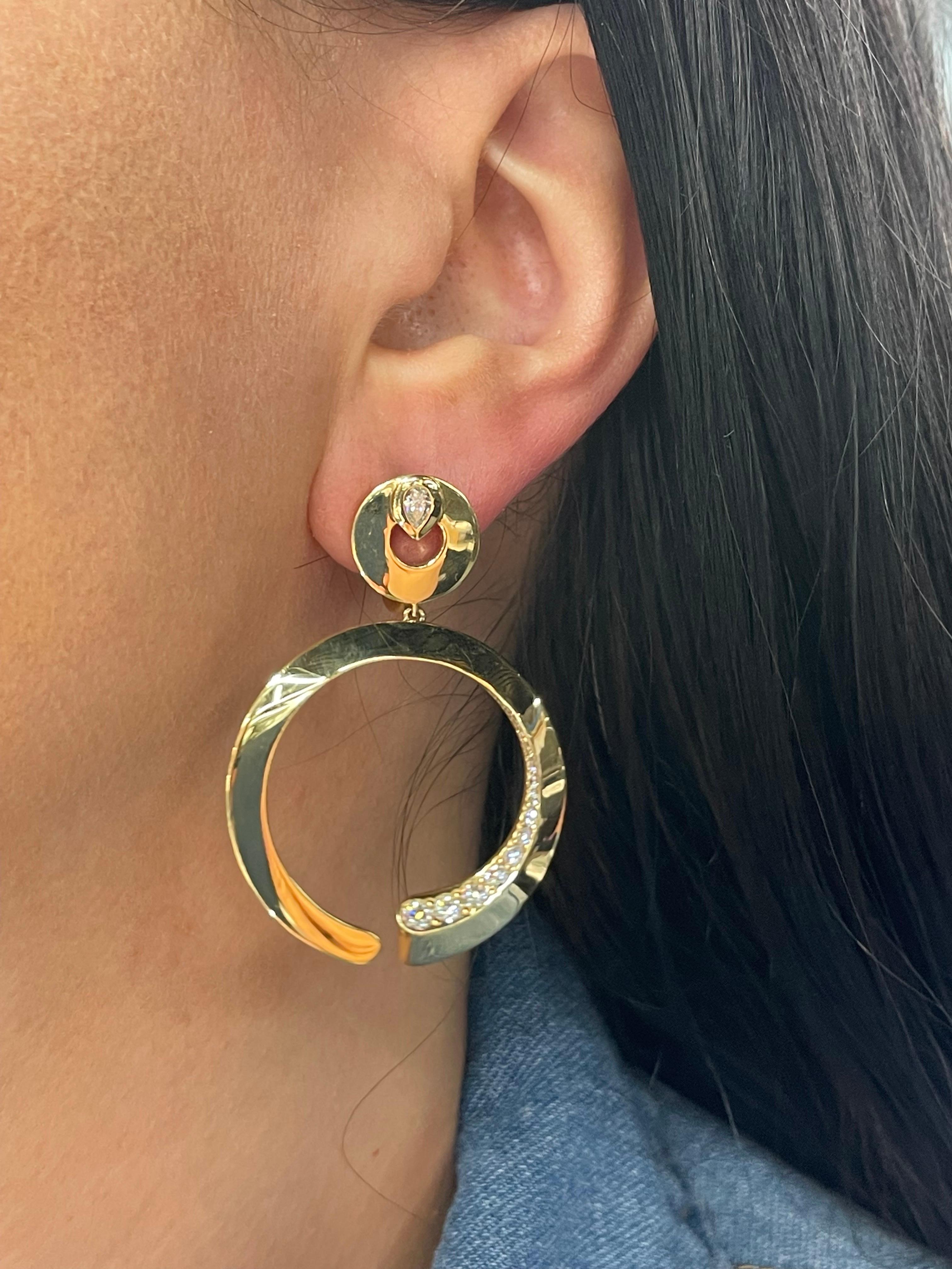 Italian 18 Karat yellow gold drop hoop link earrings featuring 32 round brilliants and two pear shapes weighing 1.20 carats.
Color F
Clarity VS
Designer: Crivelli Jewelry 

Hoop bottom measures 1.38 inches wide