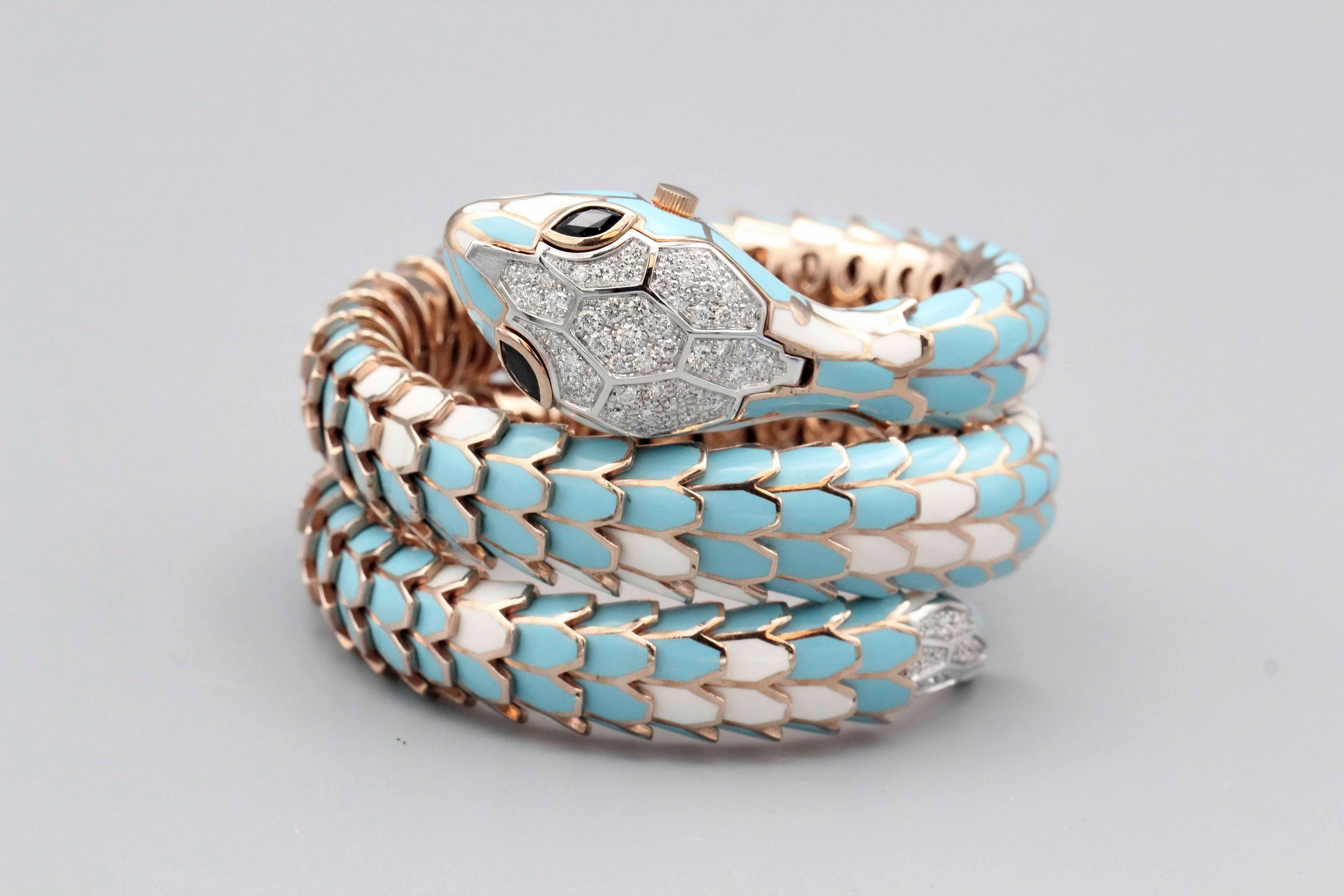 Fine Italian made snake watch bracelet, most likely by Illario whom creates snake jewelry for the likes of Bulgari.  Made in silver, with diamond set 18k white gold scales on the head and tail of the bracelet, and featuring sapphire eyes; underneath