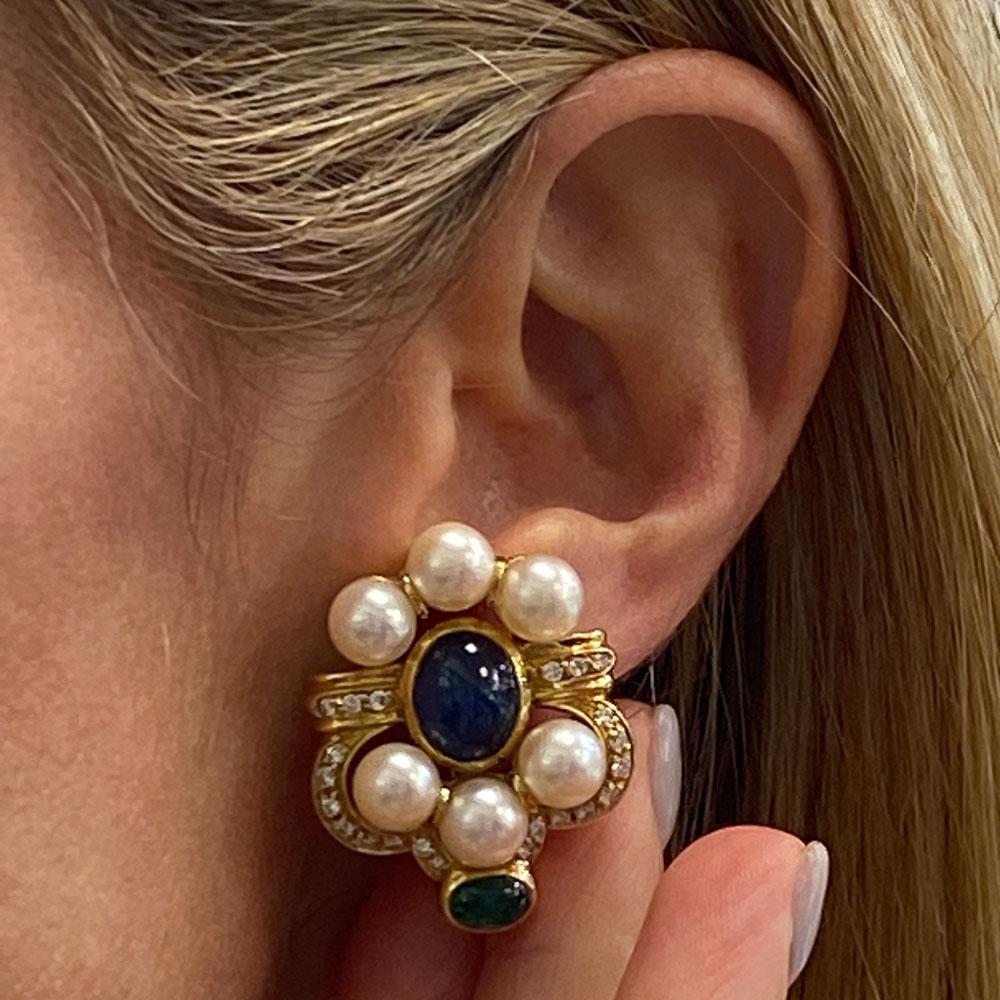 Stunning diamond sapphire emerald and pearl earrings fashioned in 18 karat yellow gold. These earrings are beautifully crafted with retractable posts, and beautiful bright gems. The two cabochon blue sapphires weigh 8.00 carat total weight, and the