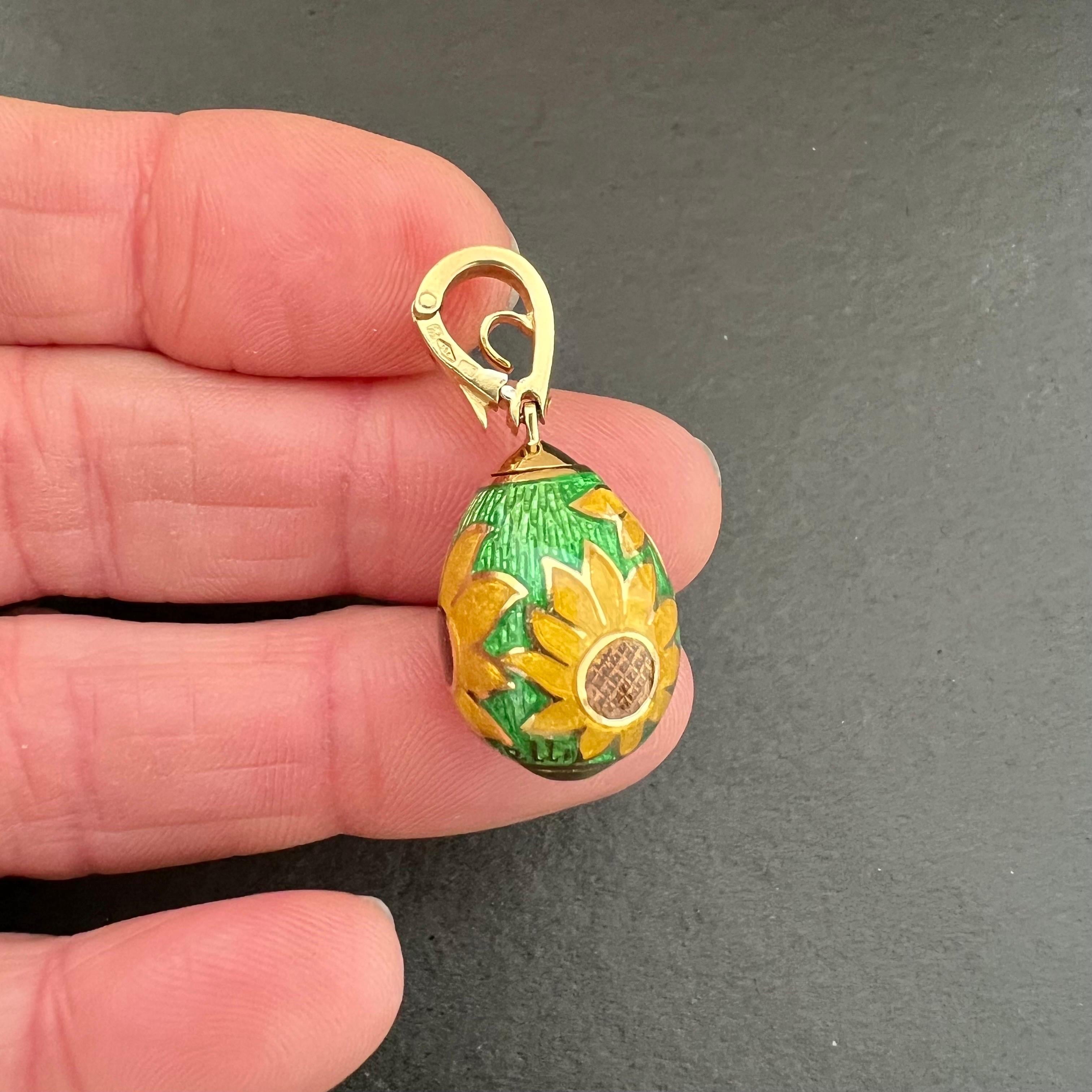 An 18 karat yellow gold Italian egg pendant designed with sunflowers and green translucent fire enamel. The pendant has one brilliant cut diamond at the bottom, which has the diamond clarity VS (very slightly included) and diamond color G (near