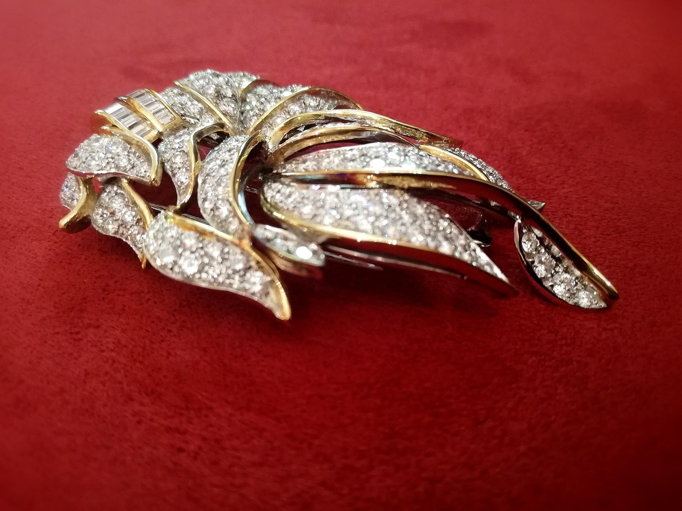 A shining and stylish brooch with a contemporary look composed of 18K Yellow Gold, baguette and brilliant-cut diamonds ( weighting respectively ct. 1,30 and ct. 11). 
Total brooch weight gr. 32,60.

E. Tropea is historically a leading business in