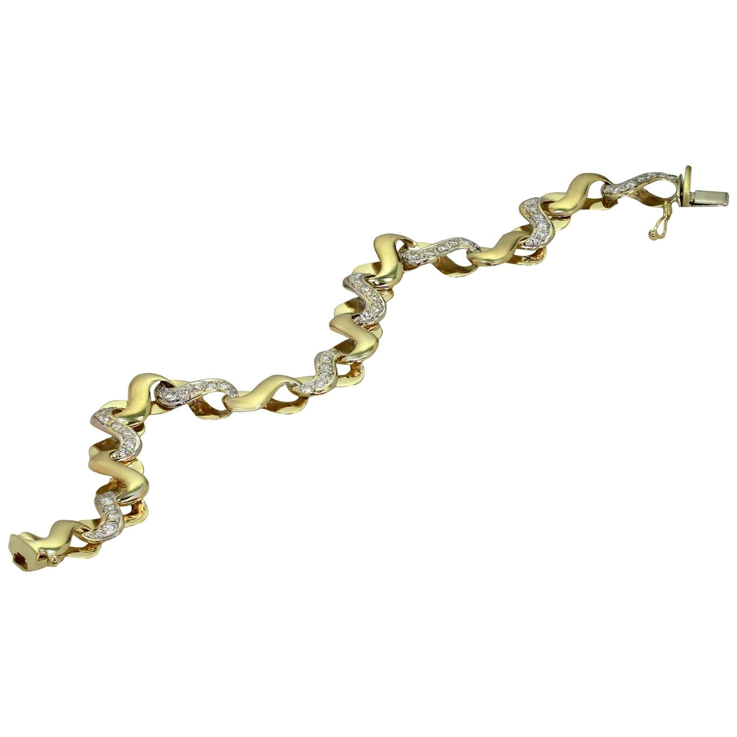 This fabulous bracelet features an elegant link design crafted in 14k yellow gold and accented with brilliant-cut round diamonds of an estimated 1.68 carats. Made in Italy circa 1990s. Measurements: 0.35