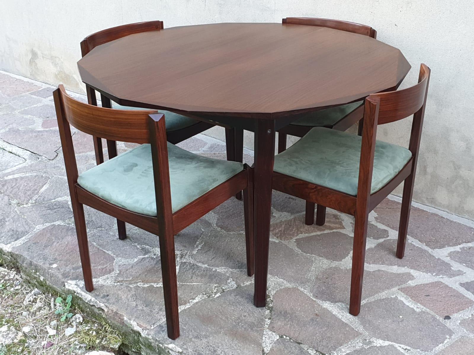 The Italian dining room table is designed by Dino Cavalli and accompanied by four chairs made for Tredici Srl Pavia. Chairs are reupholstered in green color velvet. Table is extendable for six people and extends to 65 inches.
  