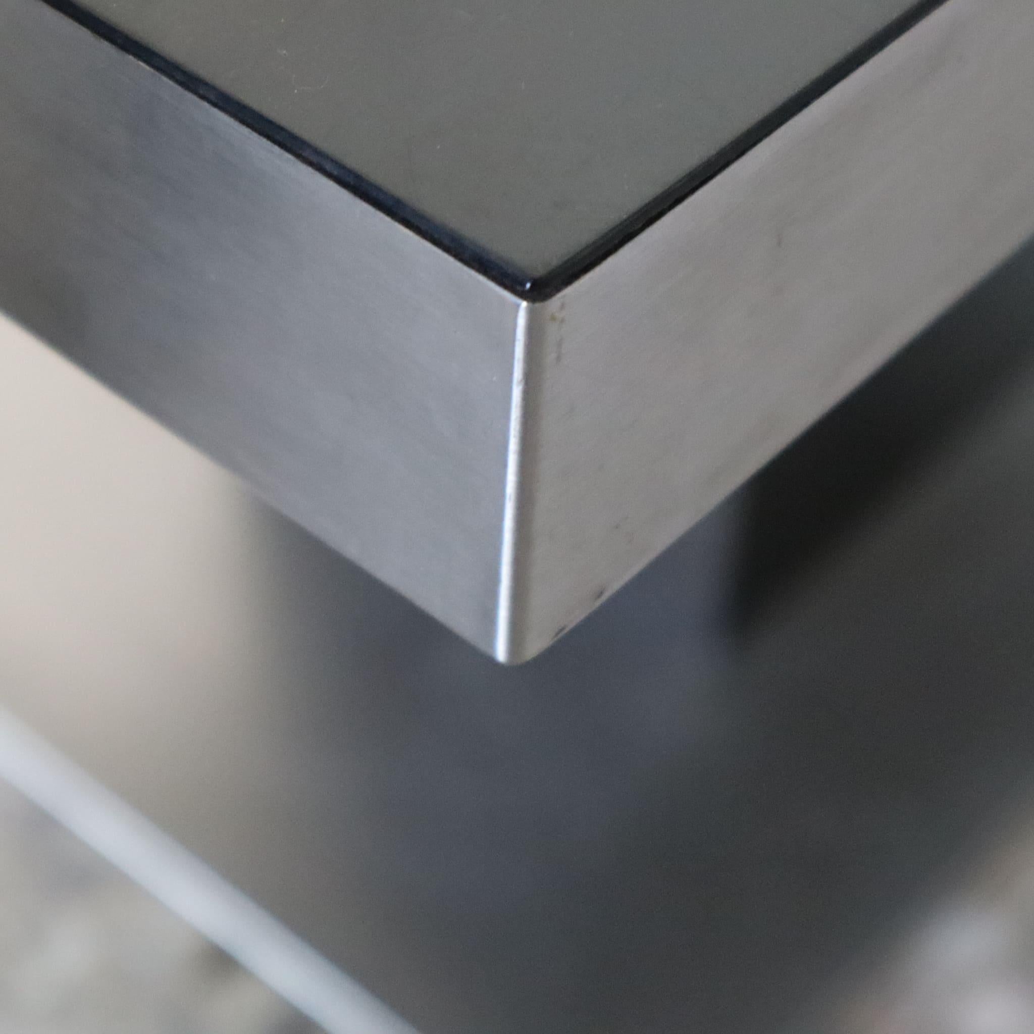 This rare and stylish dining table, designed by Willy Rizzo and produced by Mario Sabot in the 1970s, offers a perfect blend of modernist design and industrial influences. Featuring a laminate top and a robust steel sheet base, this table brings a