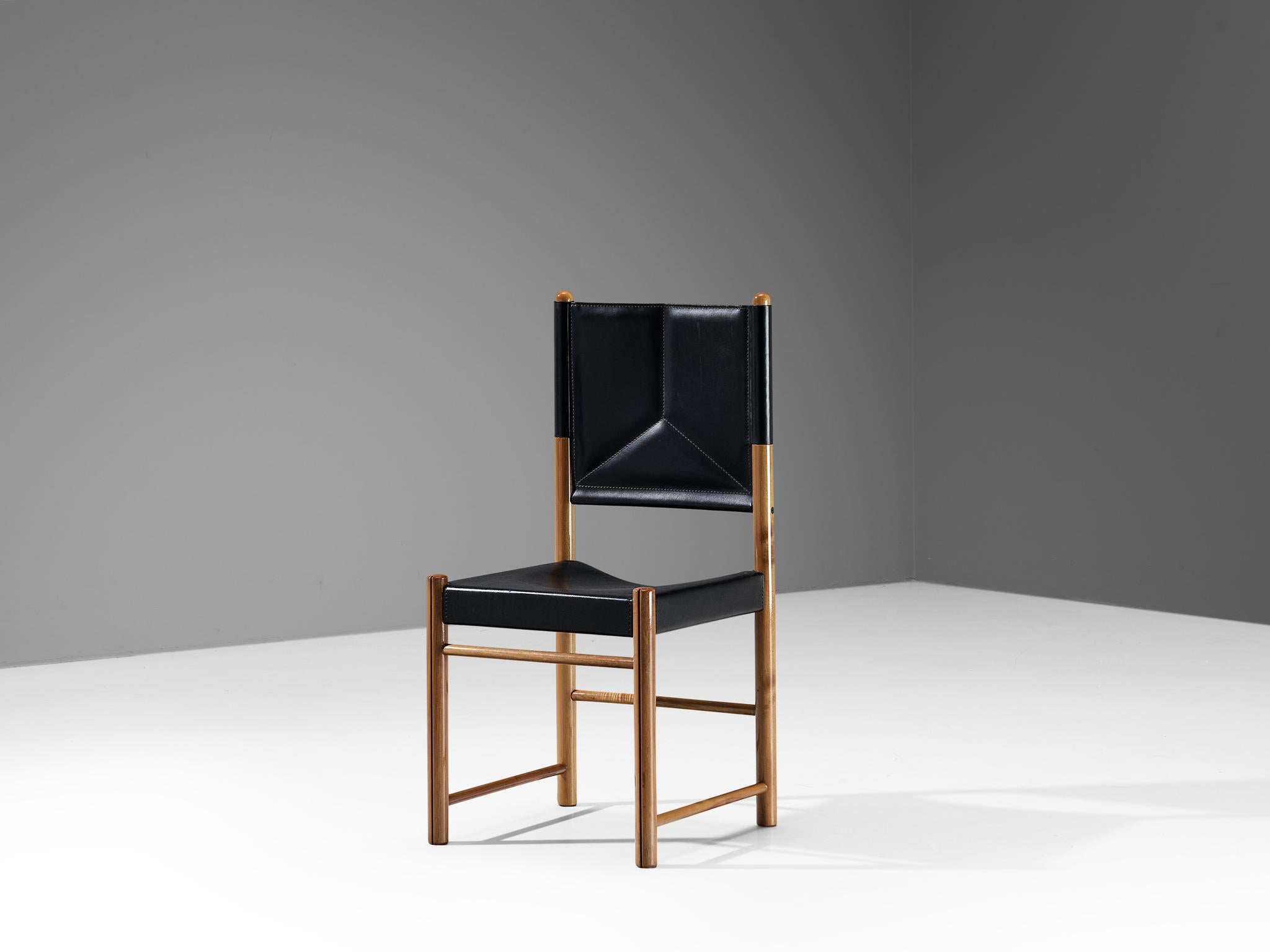 Dining chair, walnut, leather, Italy, 1970s

A delicate chair that is well-proportioned and will elevate one's interior in a vigorous and strong way. The wooden frame is composed of cylindrical beams to which the black leather is secured. The