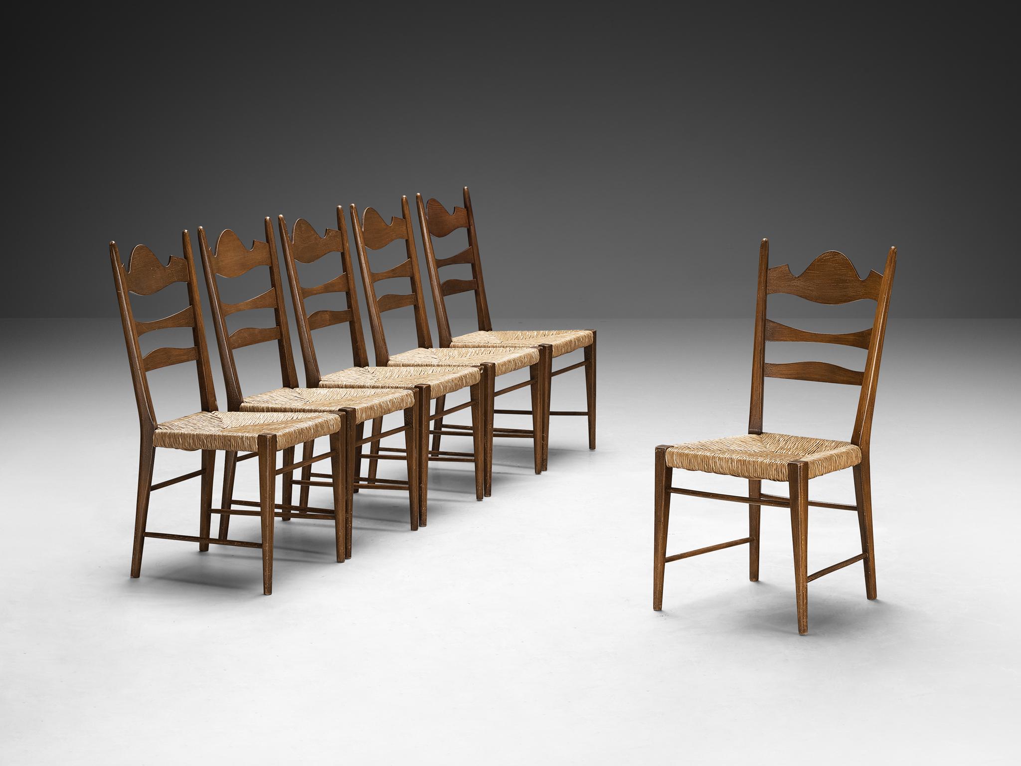 Dining chairs, darkened beech, straw, Italy, 1950s

Crafted with a refined decorative allure and a rustic inclination, these chairs present exquisite craftsmanship and intricate woodcarvings, showcasing a unique design. The backrest features