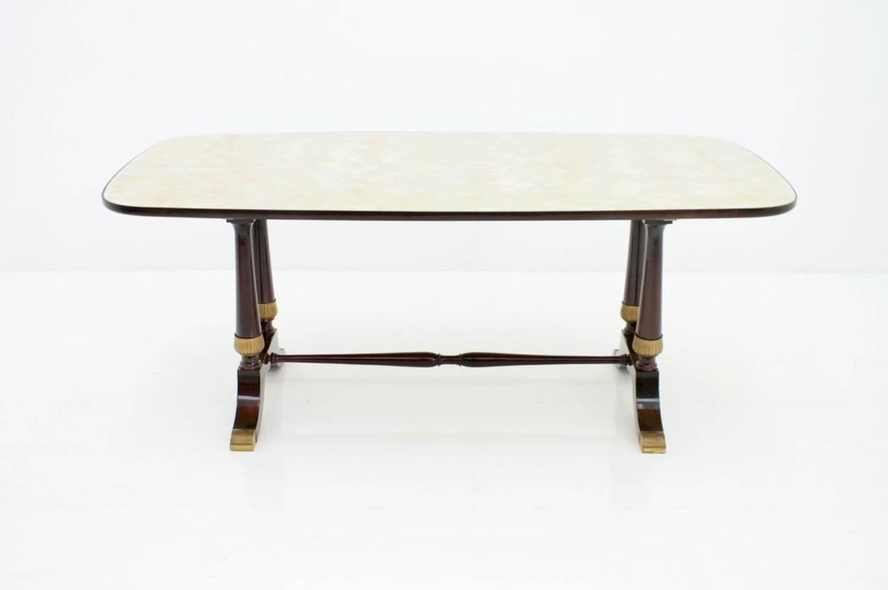 Italian table dining table from 1959. The table have a glass plate, which is framed in the black wooden frames and has a very nice grain. The legs of the table are decorated with brass. The table is Labeled with Fratelli Strada, Roma Measurements: D