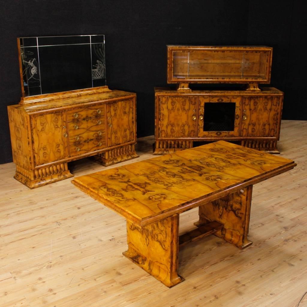 Italian dining table in Art Deco style. Furniture from 20th century carved in burl walnut wood, of great quality. It presents some signs of wear, overall in good state of conservation. Table that is part of a set with two cupboards (ask for the bulk