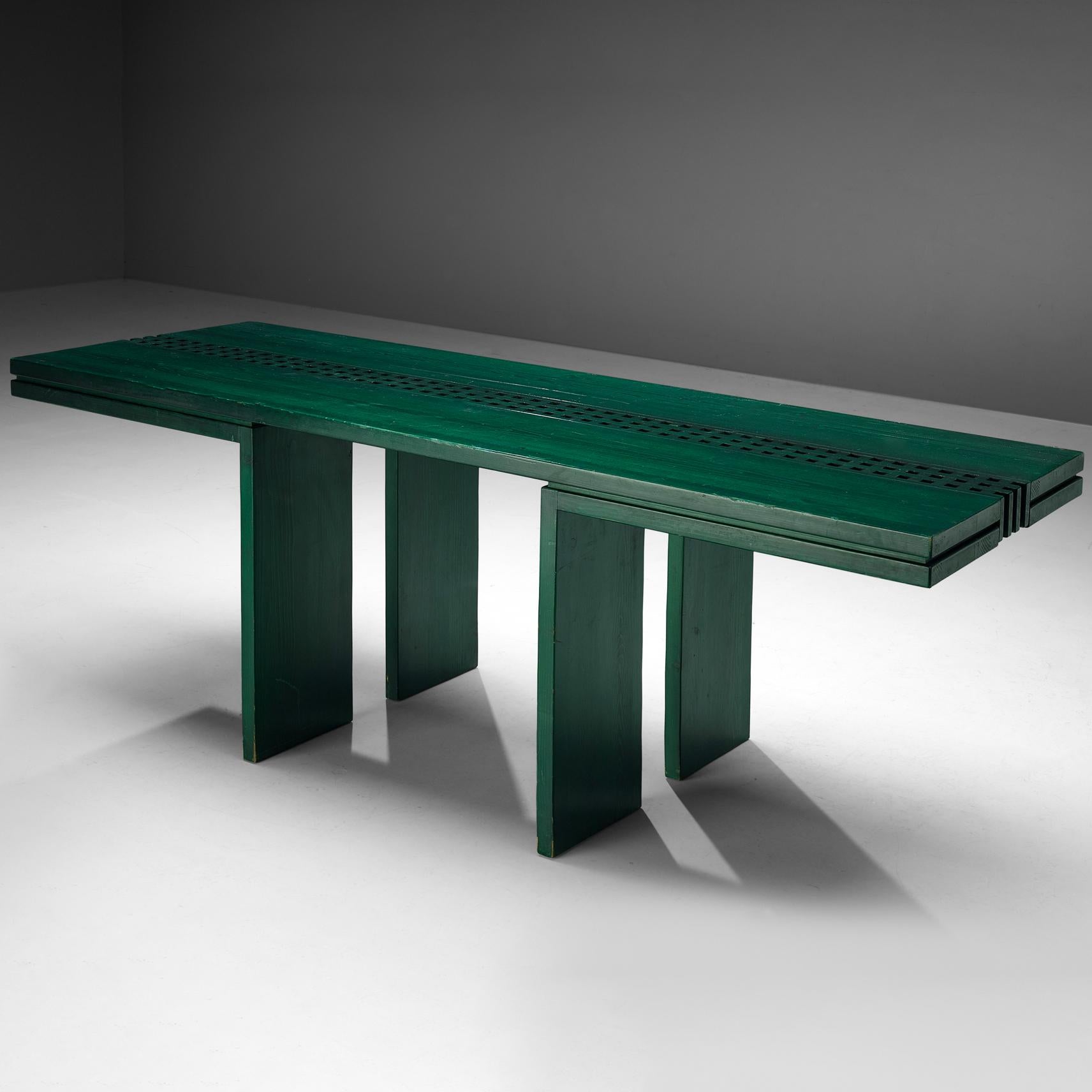 Dining table, lacquered pine, Italy, 1970s

Eccentric dining table executed in vibrant green stained pine. The shimmering glossy finish reveals the subtle grain pattern of the pine wood beautifully. Contrary to the closed frame, an open grid of
