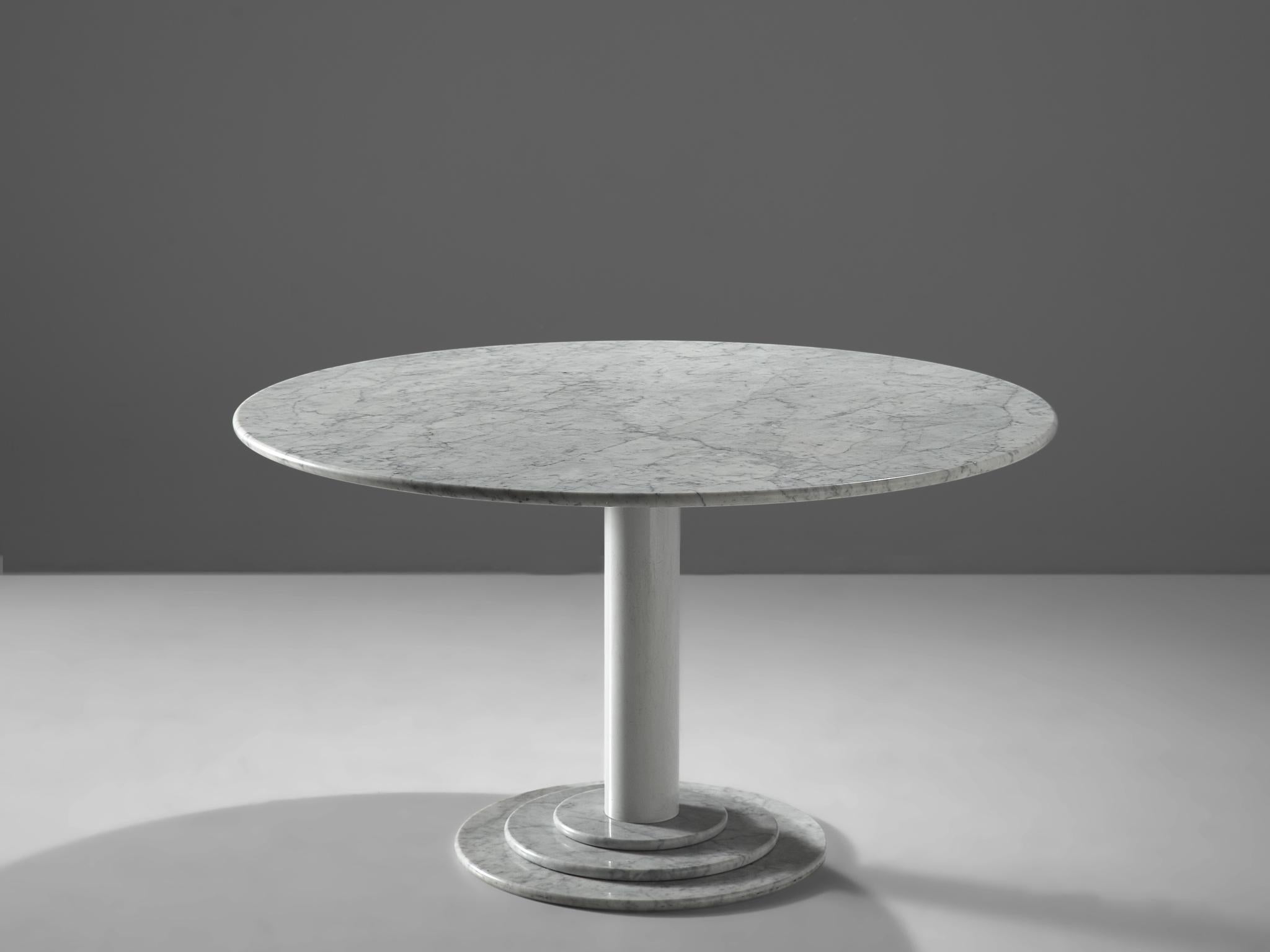Round dining table, white marble, Italy, 1970s

This table is a skillful example of Postmodern design. A white lacquered metal pedestal with a marble foot holds a round marble table top. A great classic designed in the style of Acerbis. The foot