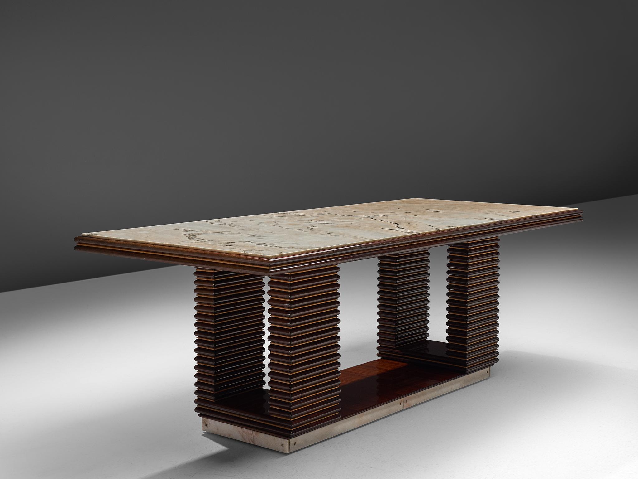 Dining table, marble and wooden legs, Italy, 1960s.

Art Deco style marble table designed with a large rectangular top and four structured, ribbed dark wooden legs. The design of this table is from the 1960s but bears strong notes of 1930s Art Deco,