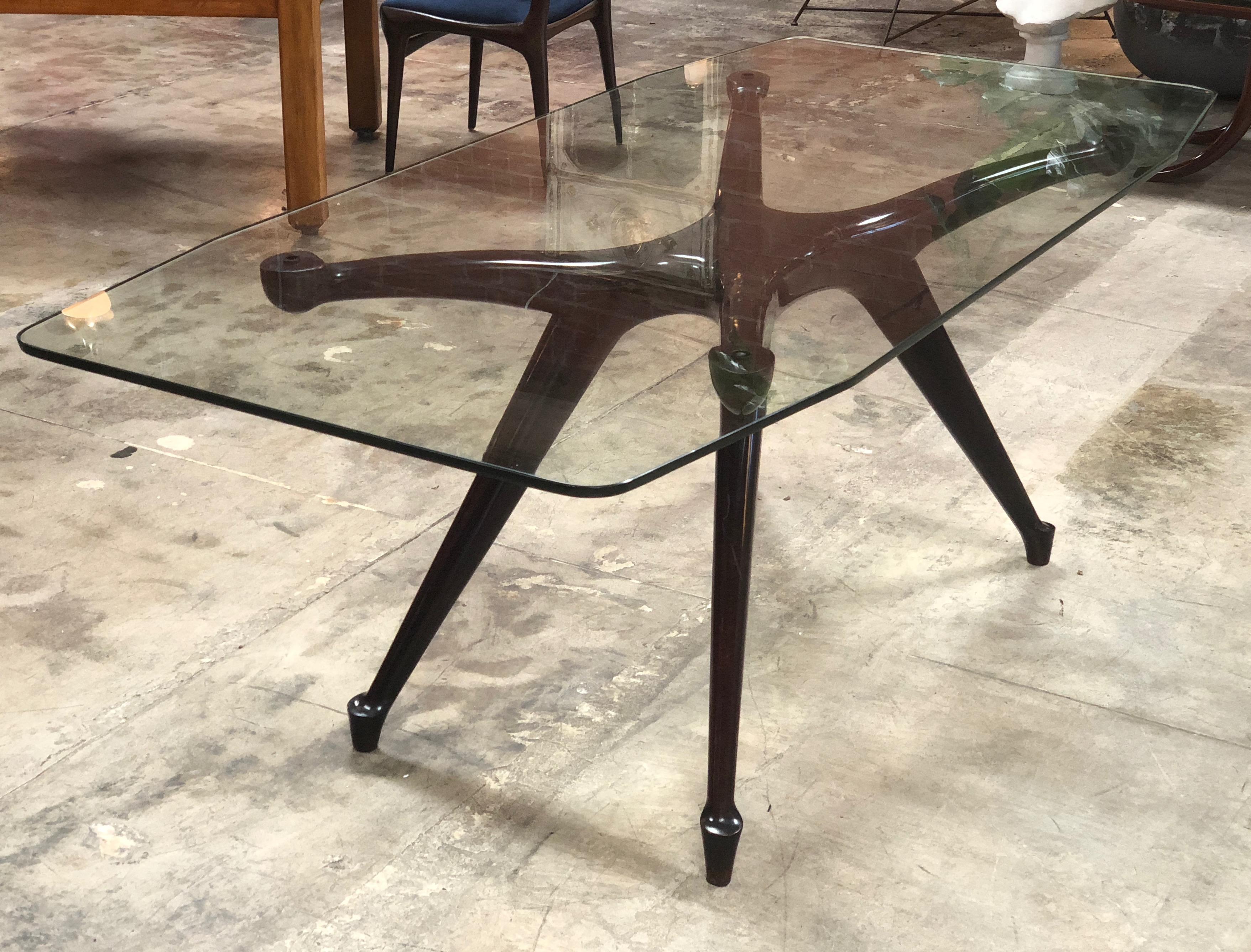 An Italian designed dining table / or could work as a great desk ebonized wood with glass top sculptural legs attributed to Paolo Buffa, circa 1950s.