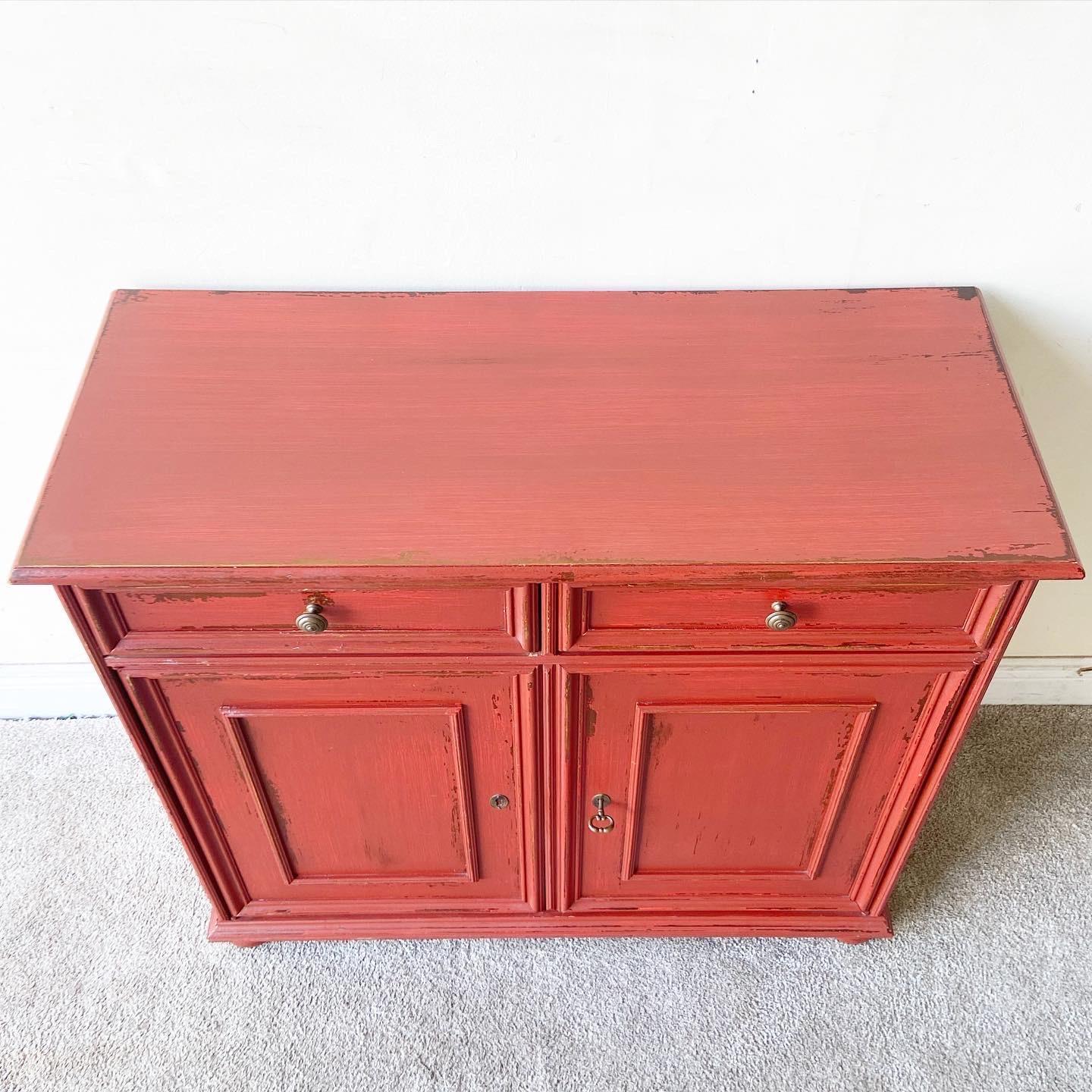 Exceptional Italian farmhouse sideboard by Buying & Design. Features a painted red distressed finish with 2 spacious drawers and shelving.
    