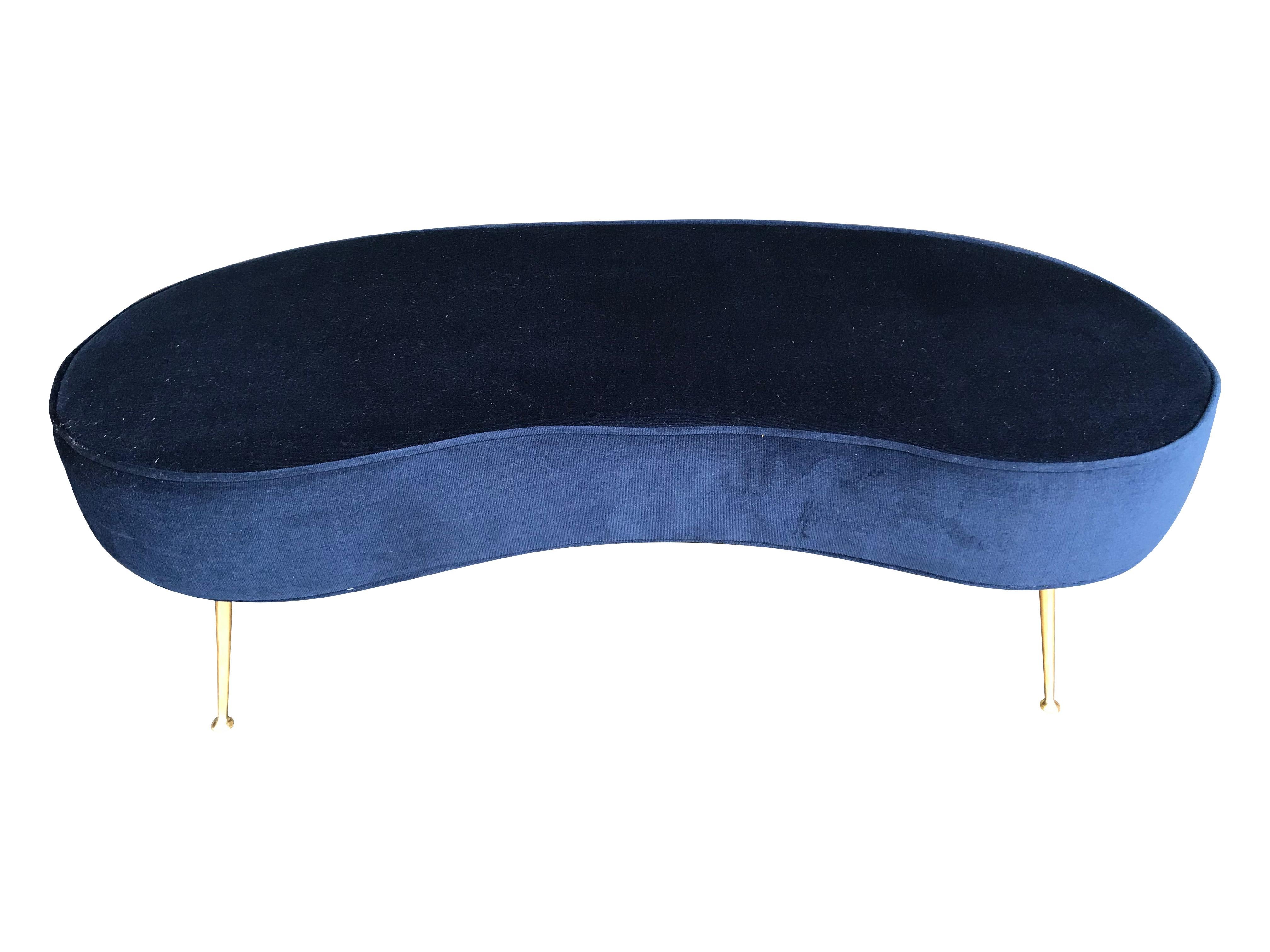 An Italian double bench with elegant solid brass legs, newly upholstered in navy blue velvet.


        