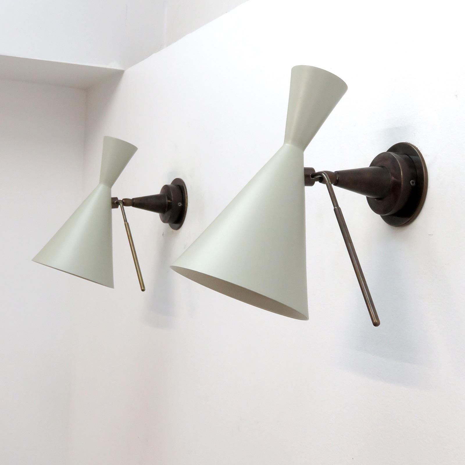 wonderful articulate Italian wall lights with off-white/light grey enameled double cone shades on dark patinaed brass armature with a pronounced handle for shade adjustment, wired for US standards, one E27 socket per fixture, max. wattage 100w each,