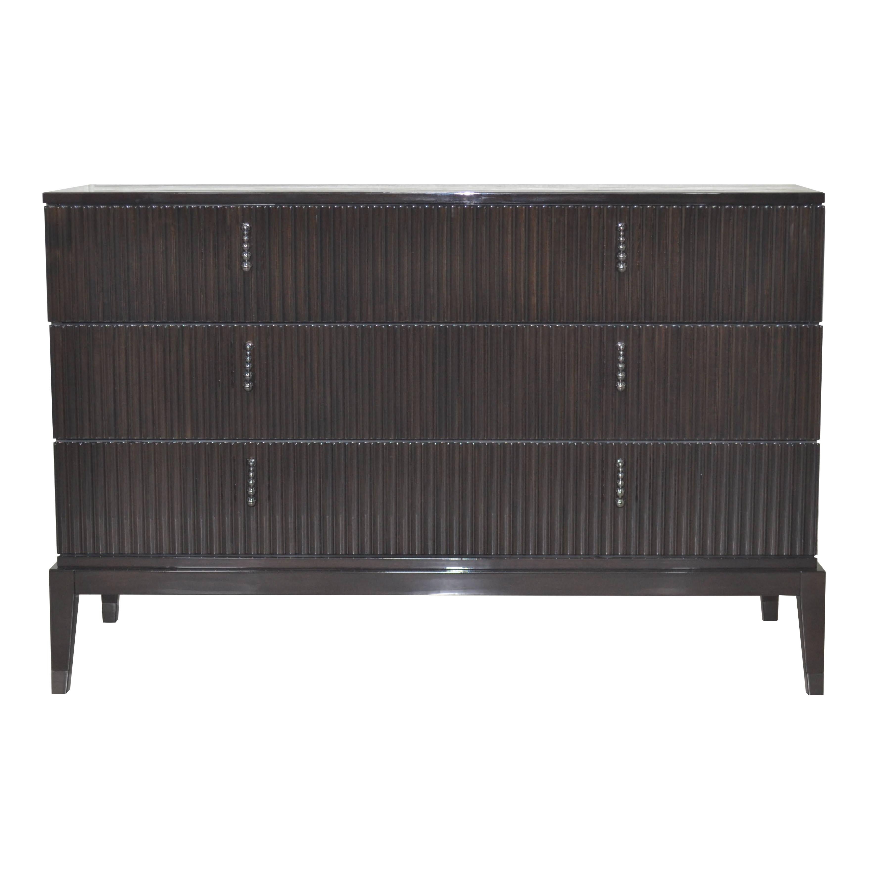Rich in storage potential, this large chest of drawers exudes Art Deco glamour with its linear design and high-gloss finishes. The drawers are upholstered inside with brown eco-friendly faux leather / vegan nubuck.