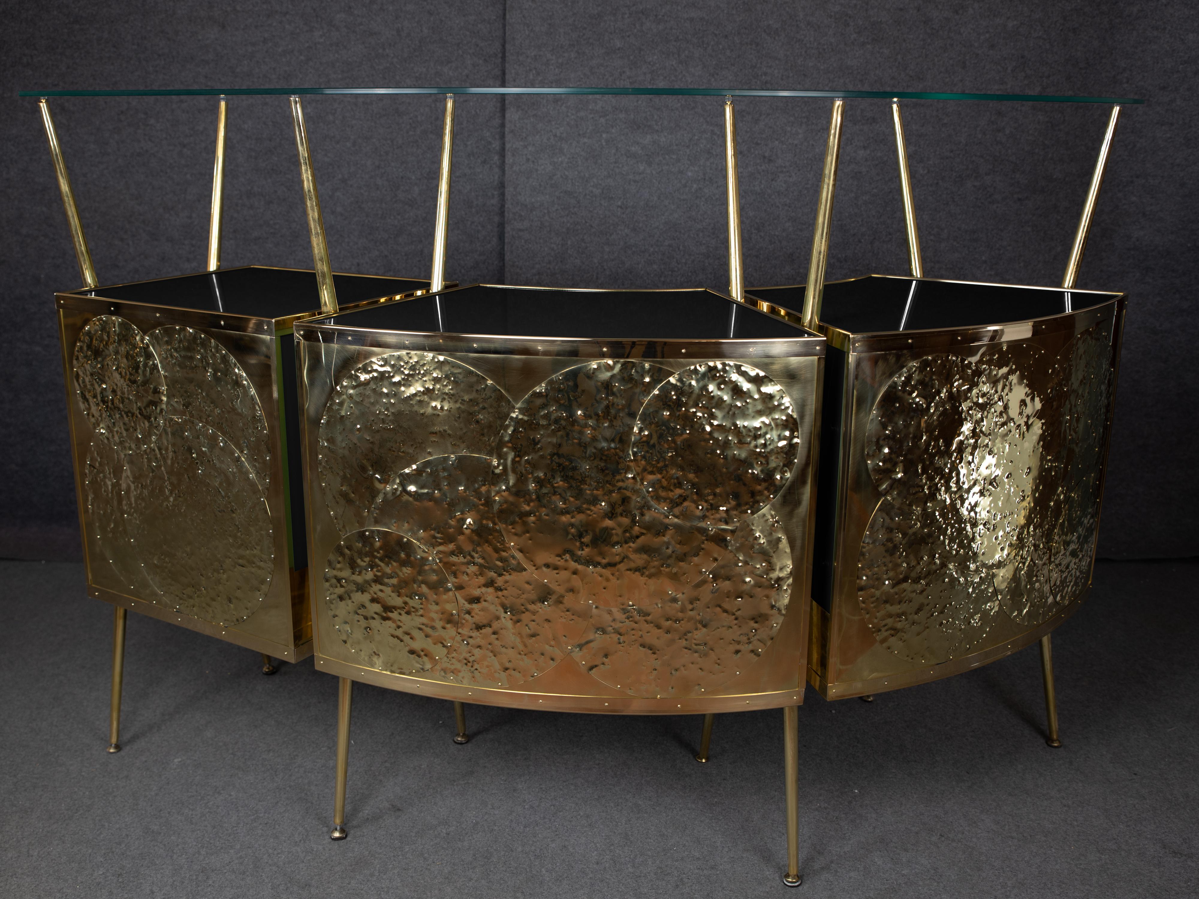 This Italian dry bar, inspired by Gio Ponti's iconic 1950s style, is a stunning piece of mid-century modern furniture. 

Crafted by the skilled artisans at JustFurnituress, it combines steam-curved wood, polished brass and tempered glass for a