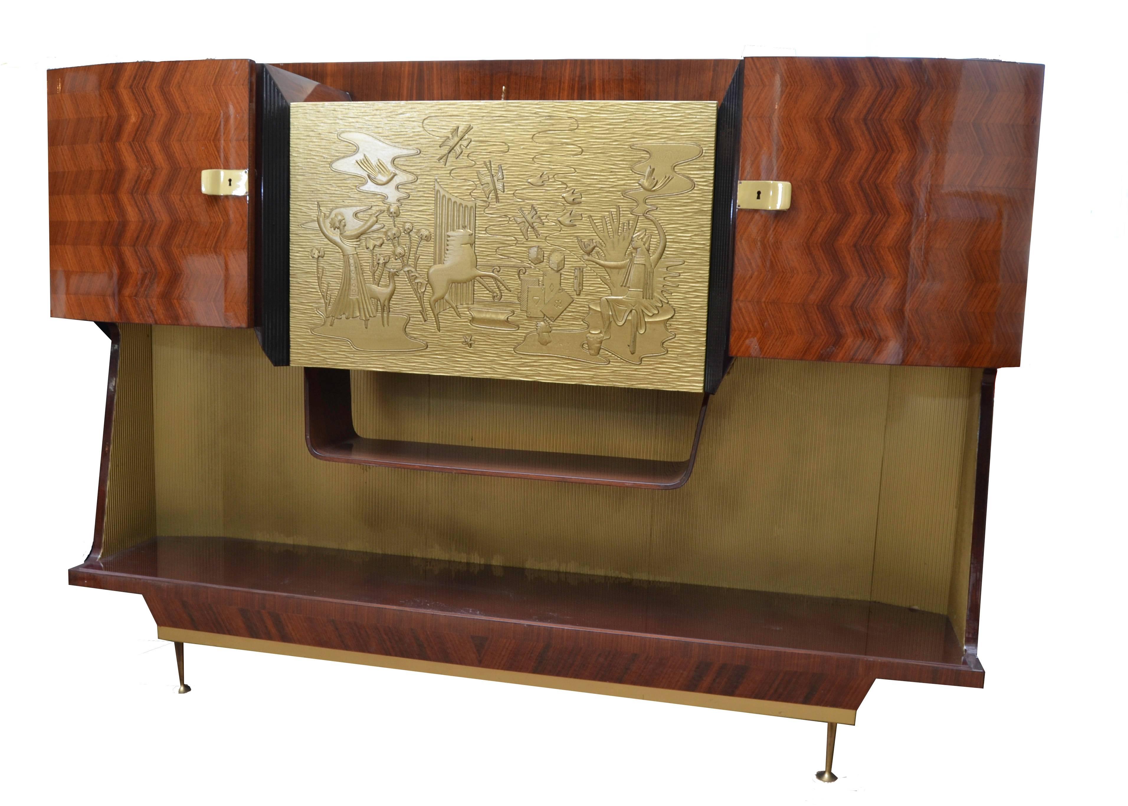 Italian dry bar from the 1940s.
Exceptional craftsmanship in wood and unique details in the hardware and keys. Gilded front panel flips forward to enable preparation of drinks. Ample storage for bottles and glasses.