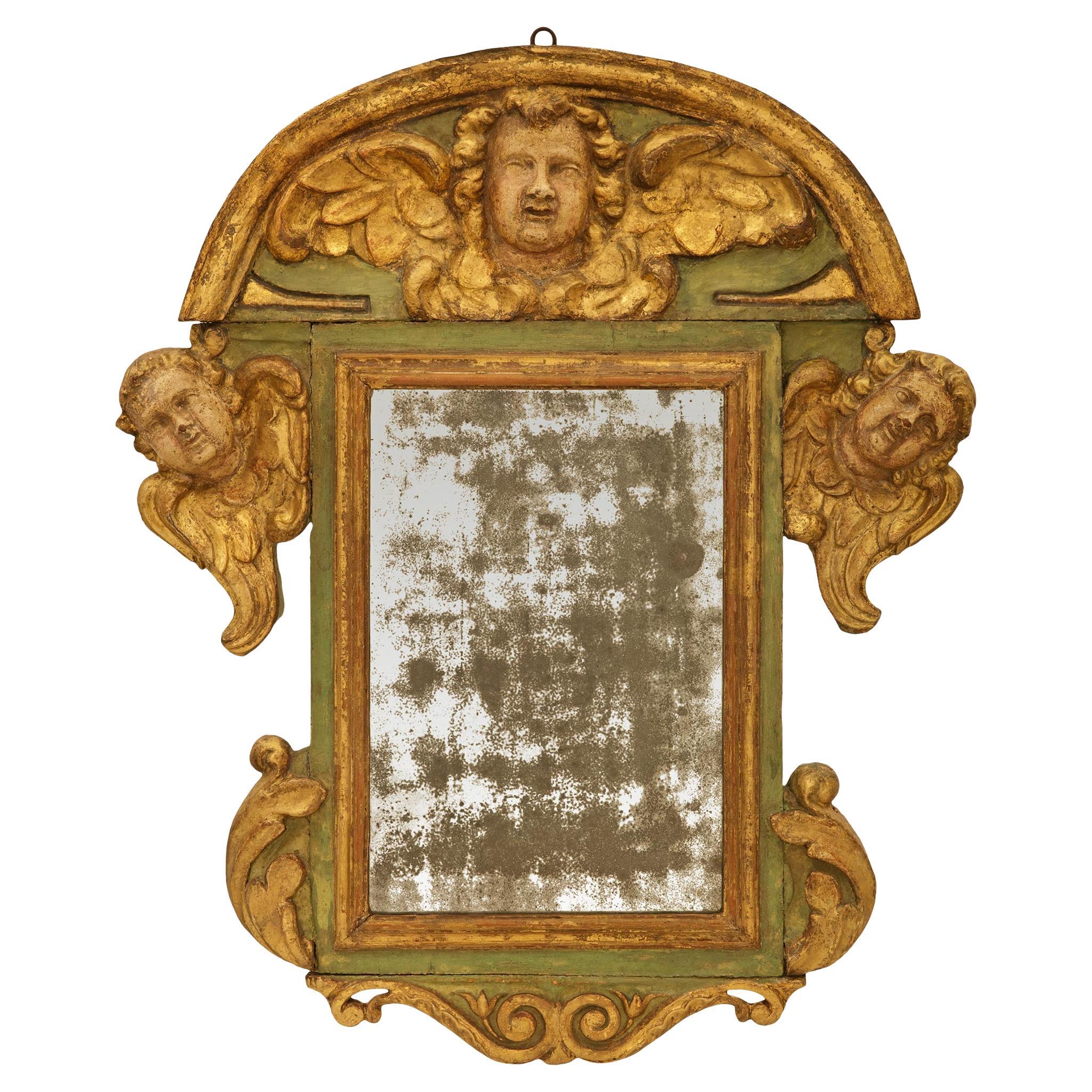 Italian early 18th century Baroque Period patinated Wood and Giltwood mirror For Sale