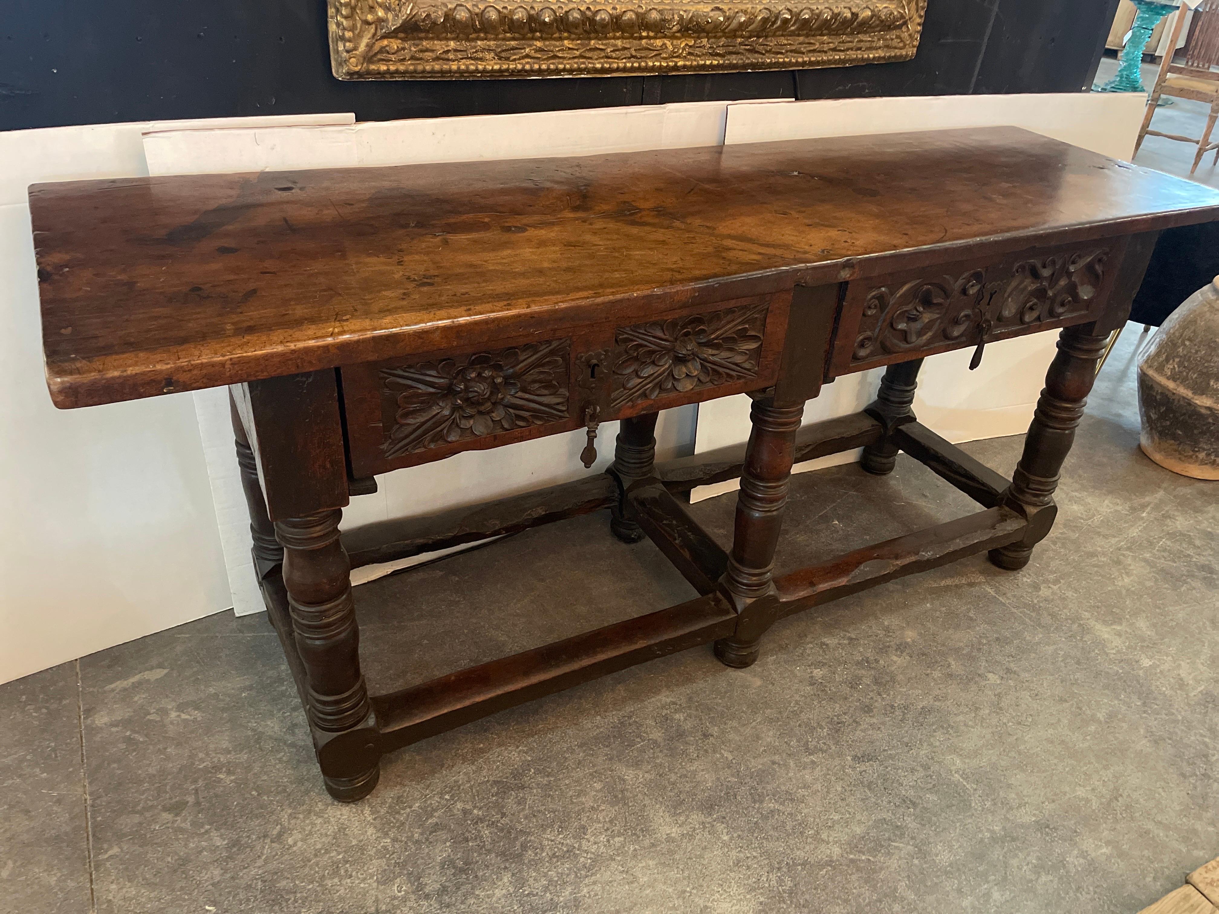 Incredible 17th to 18th century single board top table with gorgeous carved drawers and character though-out this handsome piece. Even on the backside there is painted scroll work.  The patina has a warm touched many times over look of honey.  Very