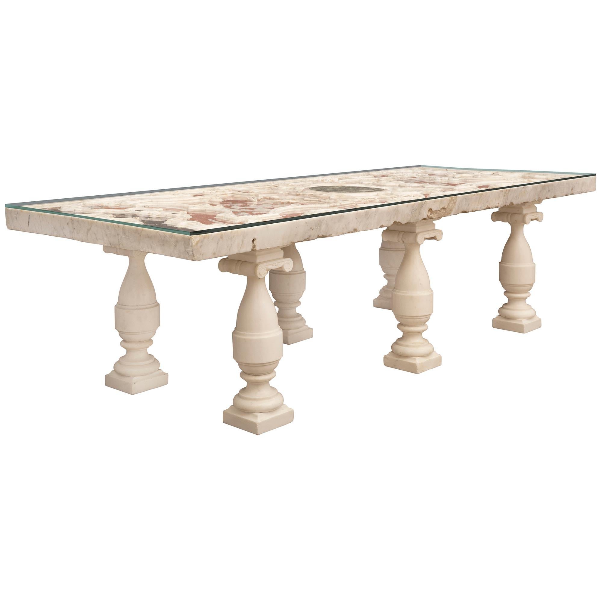 A sensational and rare Italian early 18th century Louis XIV period marble plateau coffee table. The rectangular plateau is raised by striking 19th century baluster shaped white Carrara marble supports with square bases, beautiful mottled designs,