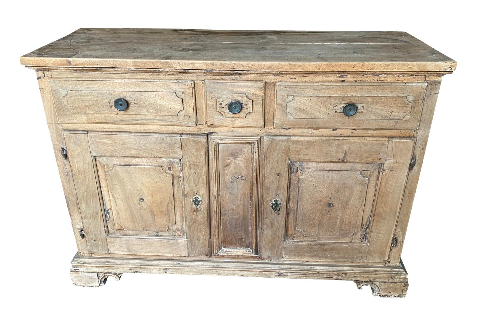 A very handsome early 19th century Credenza from the Genoa region of Italy.  Beautifully constructed from walnut with 3 drawers over double doors, interior shelving raised on bracket feet.  Wonderful patina.