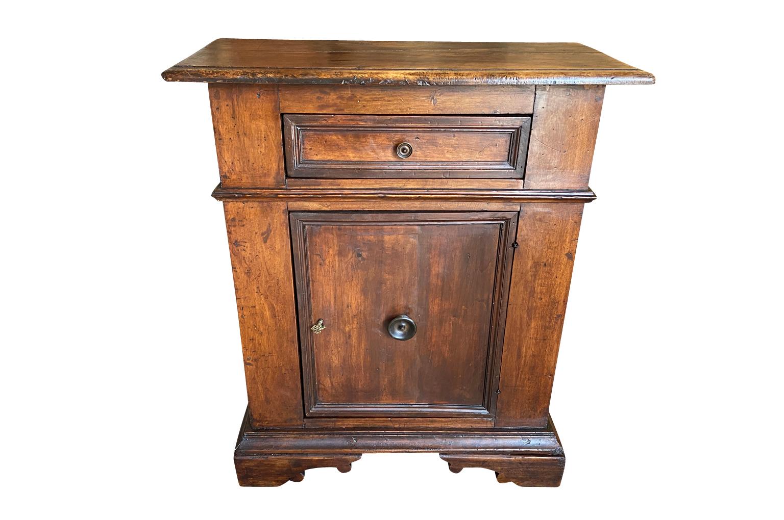 A very handsome early 19th century Credenzino from the Lombardy region of Italy. Beautifully constructed from walnut with one drawer, one door, interior shelving raised on bracket feet. Lovely patina - warm and luminous.