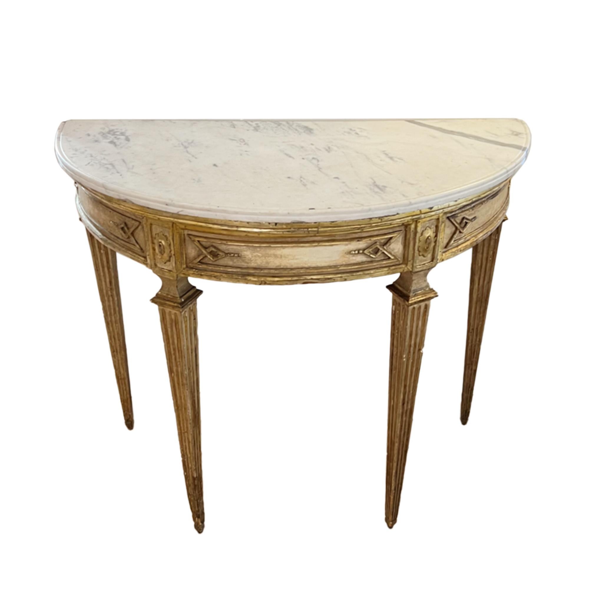 This is a beautiful giltwood console table made in Italy in the early part of the 19th century. Please take a look at our pictures to see all the carved details and the lovely marble top. 

An elegant design with tapering legs and decorative