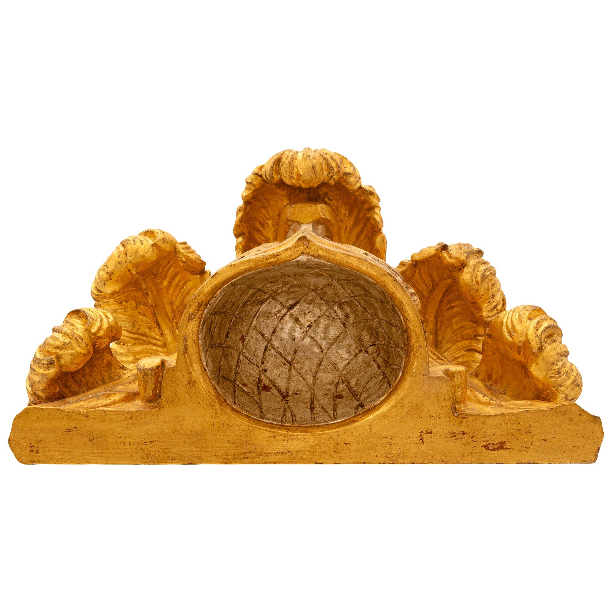 A beautiful and very unique Italian early 19th century Mecca and Giltwood Centurion helmet wall decor. This impressive wall mounted helmet displays a richly carved Giltwood front brim below the Mecca body showcasing striking Giltwood Rocaille
