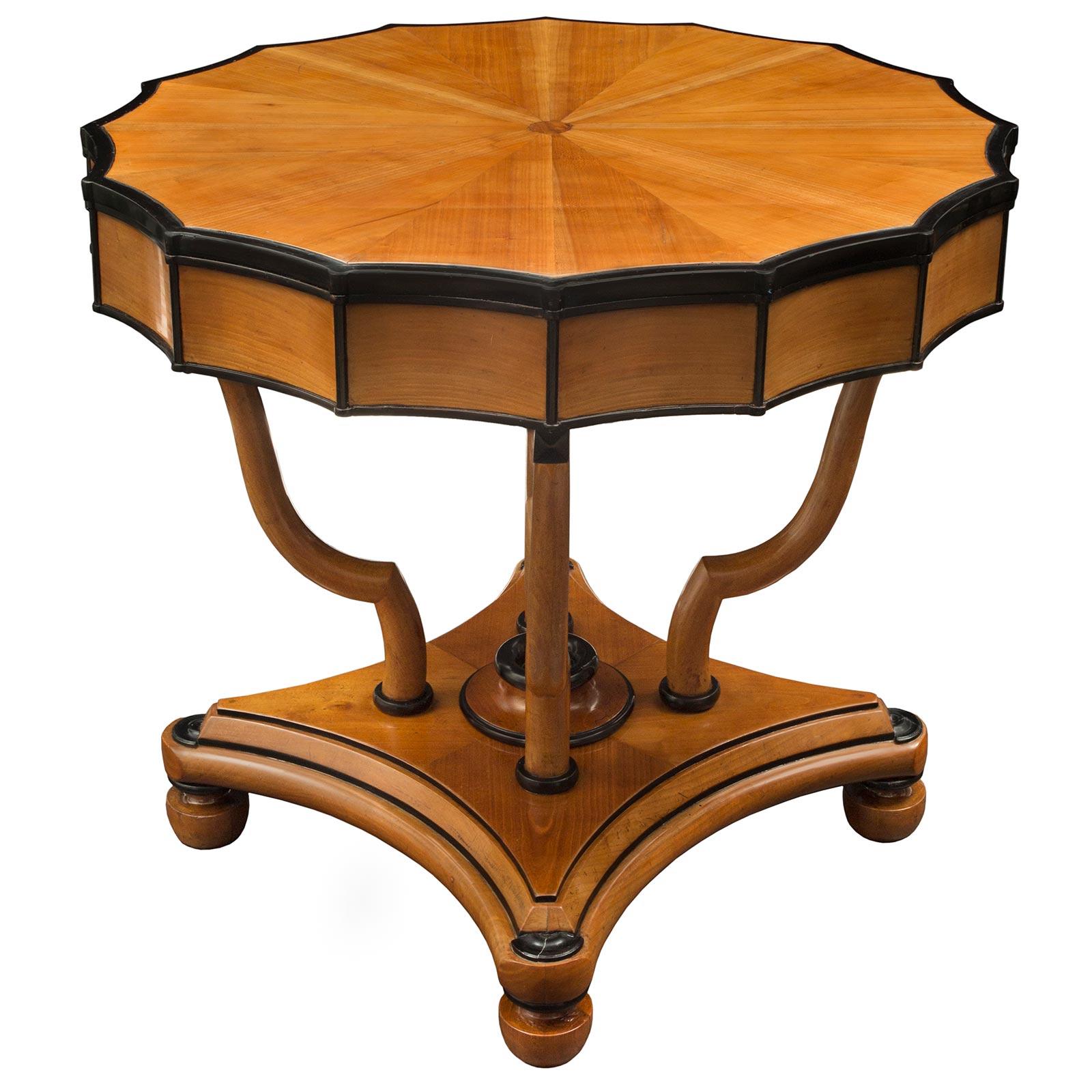An exceptional and uniquely shaped Italian early 19th century Neo-Classical st. cherry and ebony side table. The table is raised by a square mottled support with concave sides and decorative half round rosettes at each corner all above topie shaped