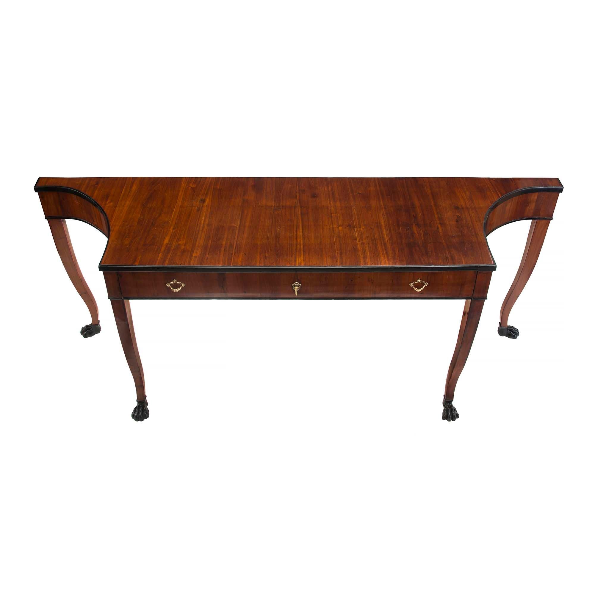 A very handsome and unique Italian early 19th century Neo-Classical st. mahogany and ebonized fruitwood console. This free standing console has four tapered slightly curved legs ending in ebonized fruitwood hoof feet. The wide drawer at the frieze