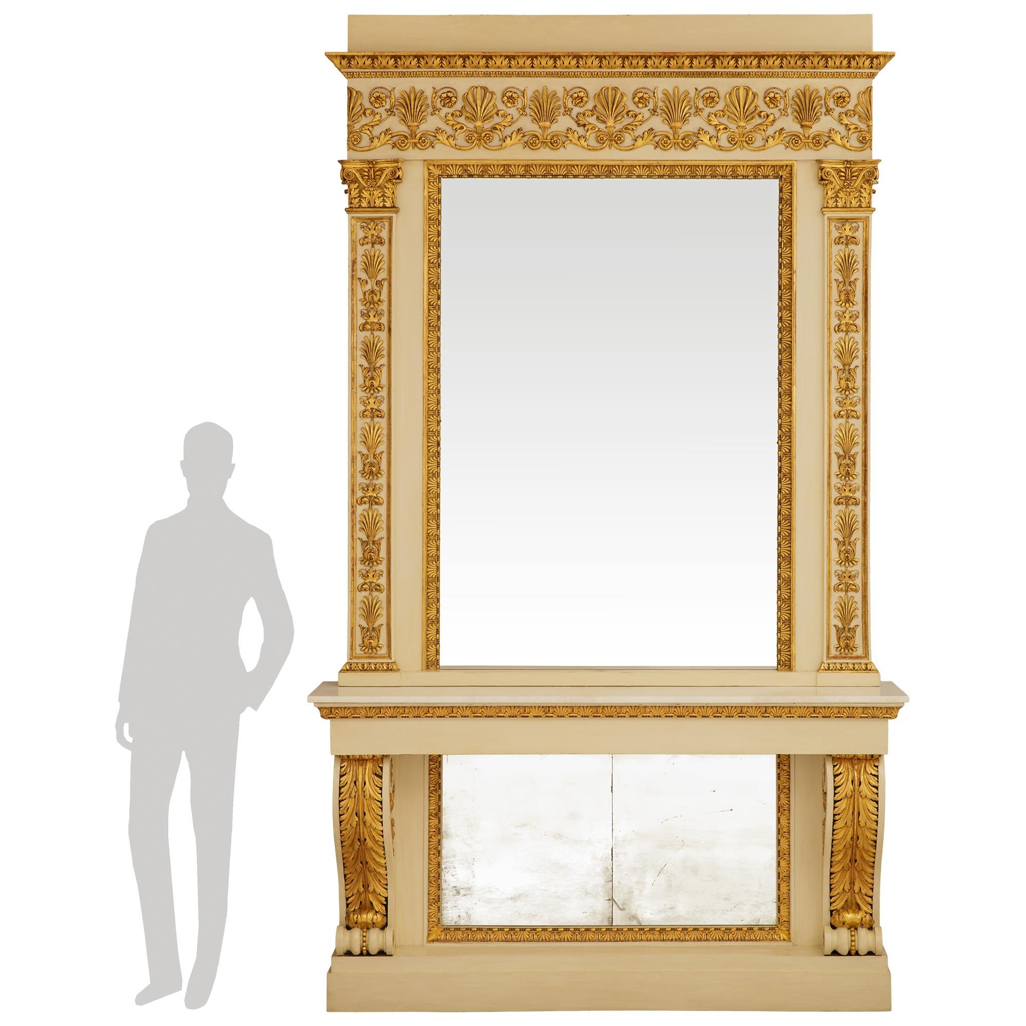 A spectacular and grand scaled Italian early 19th century Neo-Classical st. patinated Wood and Giltwood matching console and mirror. This exceptional console is raised by a square patinated Wood plinth leading up to a central mirror plate trimmed