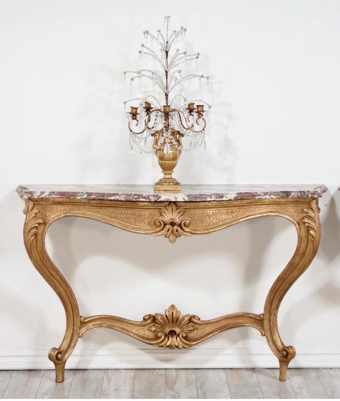 Fantastic, pair of early 20th century Italian Louis XV style carved gilt-wood console tables with marble tops.

These antique consoles feature beautifully carved gilt details including curvaceous cabriole legs, rocaille stretchers and cartouche