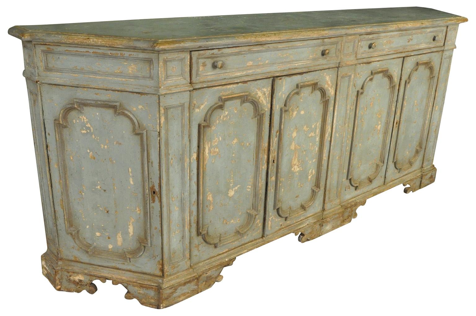 A stunning early 20th century credenza from Italy. Beautiful shape and lines and soundly constructed from painted wood. Terrific finish and patina. Wonderful narrow depth.