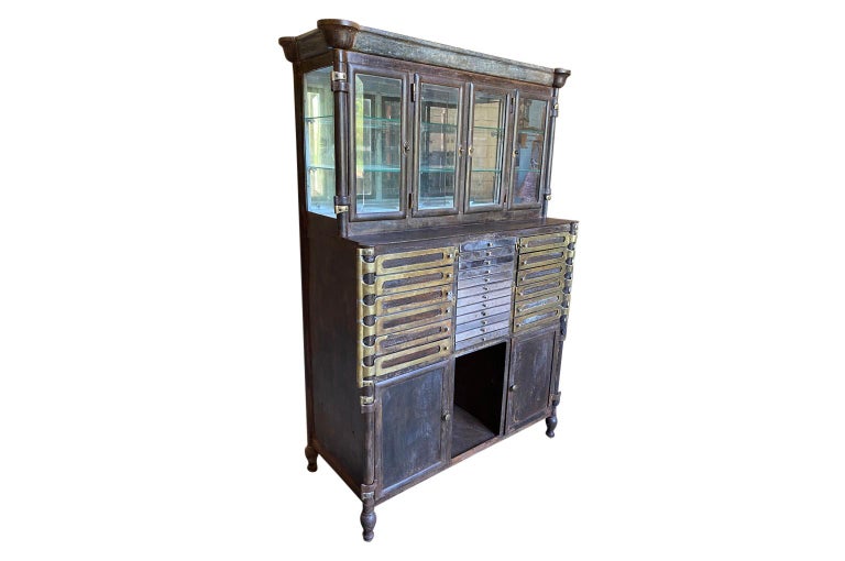 A sensational early 20th century Dental Cabinet from Florence, Italy. Beautifully manufactured in iron with 24 drawers and 6 doors. A fabulous additional any any dentist's office or used as a bar cabinet.