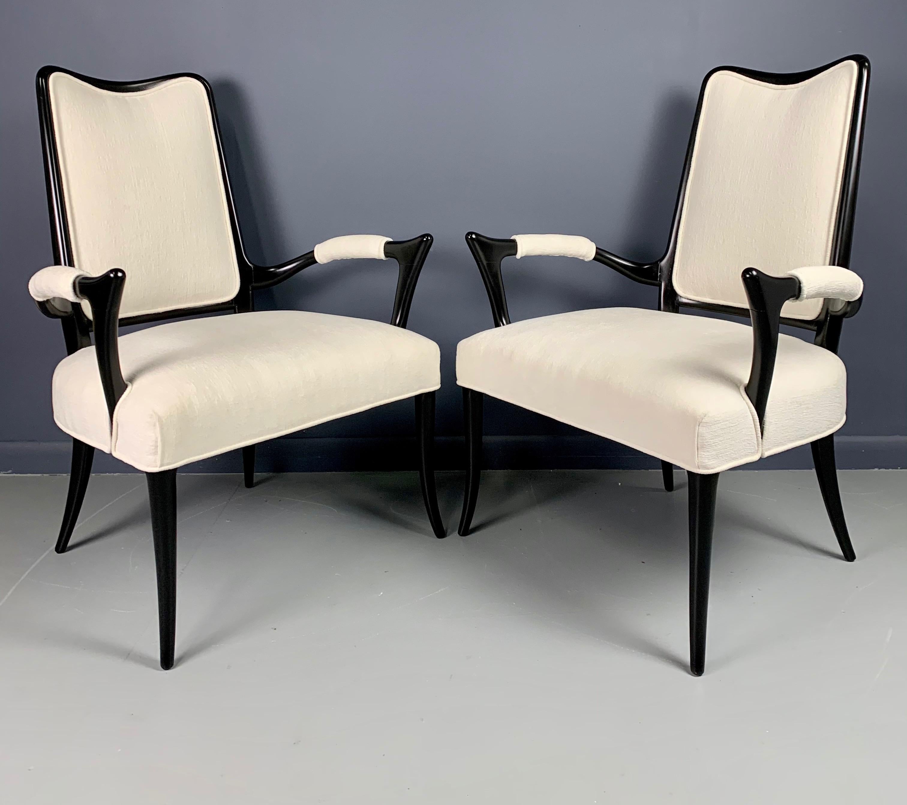 Wonderful and generously sized pair of armchairs with splayed legs and sculptural frame, the back is just a pretty as the front, upholstered in a textured white velvet.
