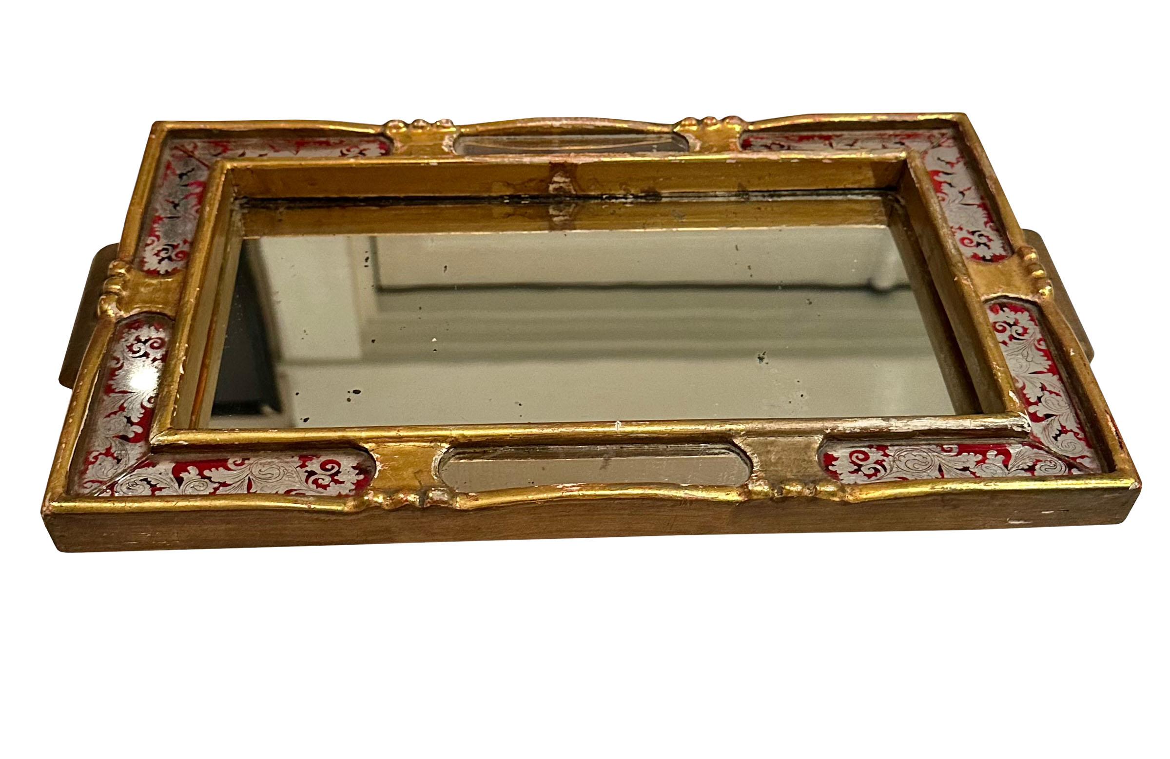 A turn of the century eglomise gold gilt tray from Italy. A perfect serving tray or as a table display.