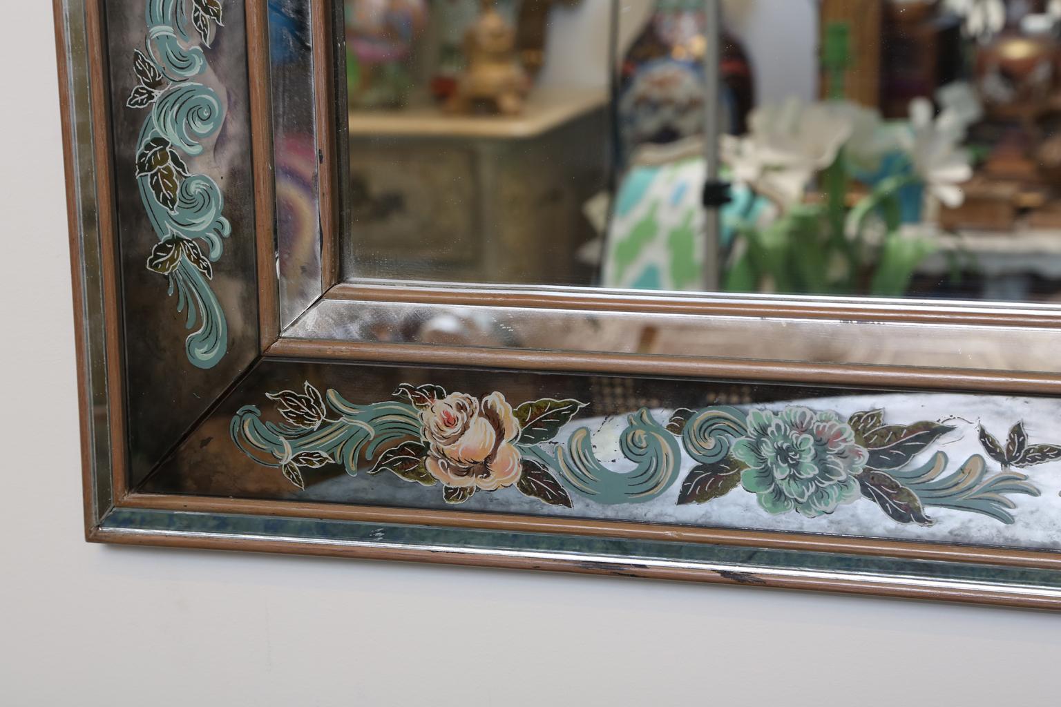 Mirror, having a rectangular frame of mitered, mirrored reliefs, a reverse hand painted églomisé border.

Stock ID: D2050.
